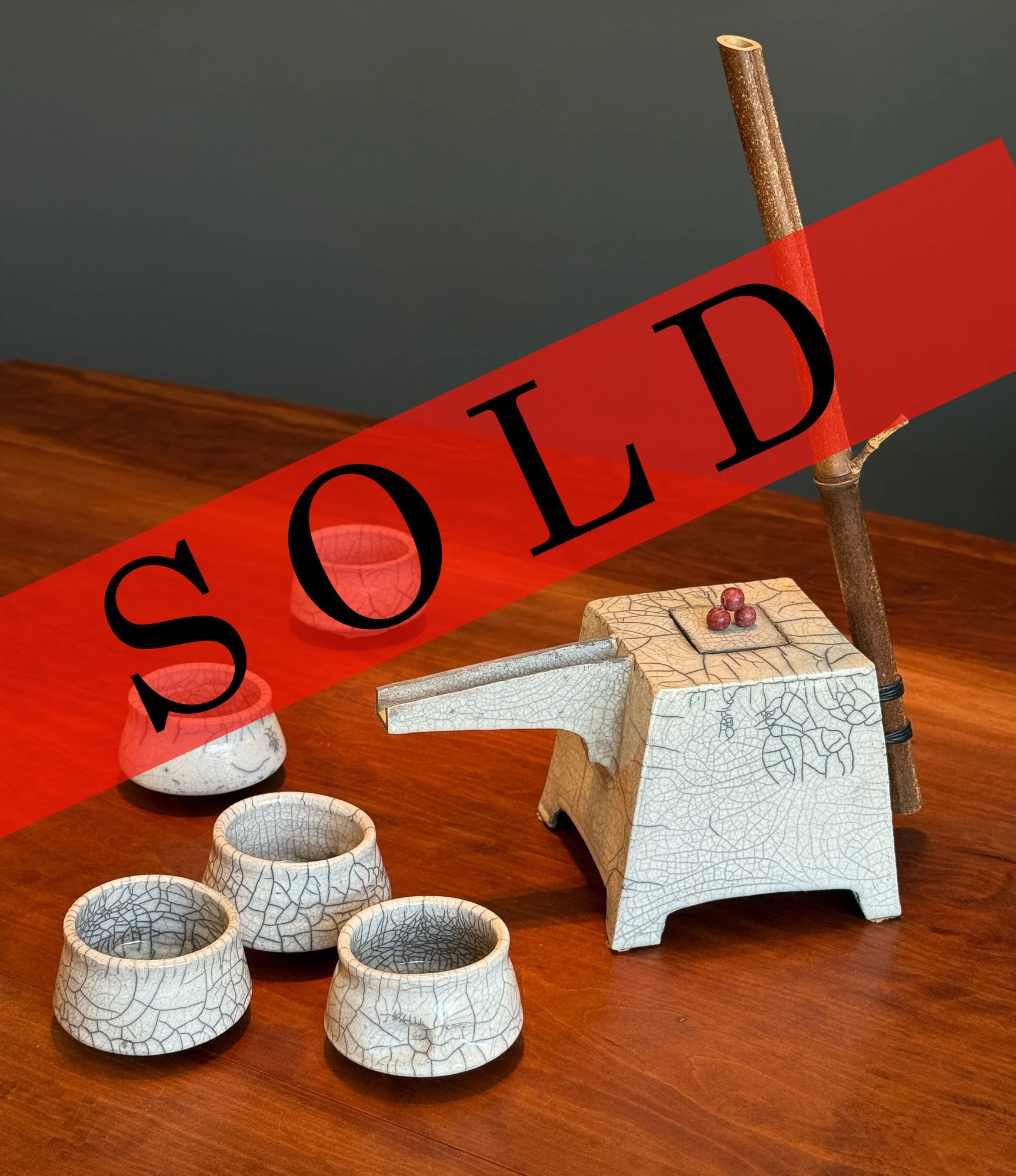   Decorative teapot and cups by Dina Angelwing   $121. Approx 14” tall with handle 7” x 7’ - RAKU technique  Raku Ceramic teapot with 5 teacups. Details of bamboo handle and berries on lid. Dina Angel-Wing, the well known Bay Area ceramic artist has 