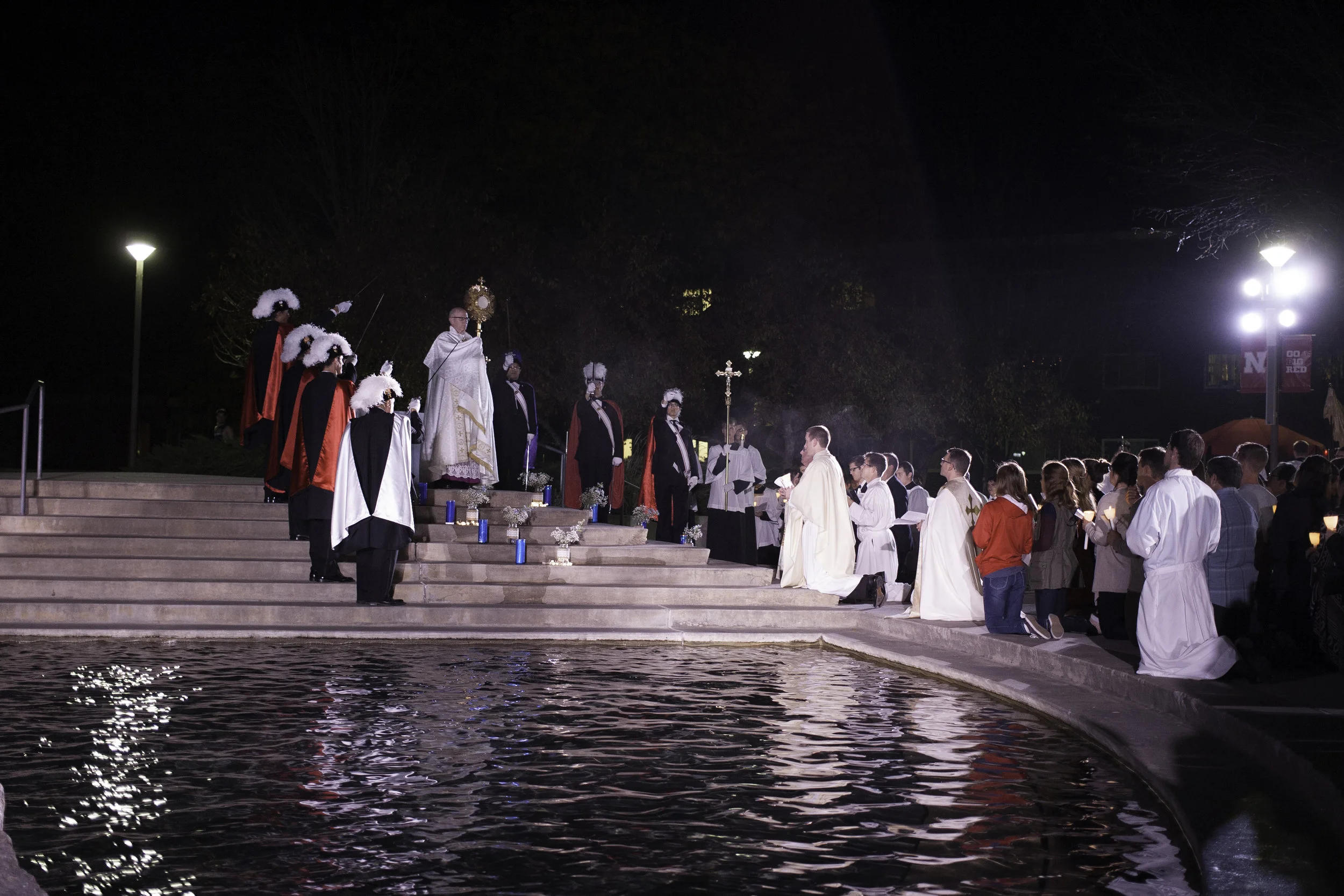 Bishop Conley holds the Eucharist by the Broyhill Fountain on the Nebraska Union Plaza as part of the Newman Center's annual Eucharistic Procession. 