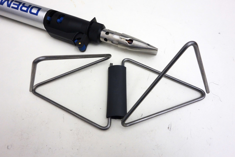 With a heat gun, shrink open ends of the tetrahedrons until you've got a kaleidocycle..