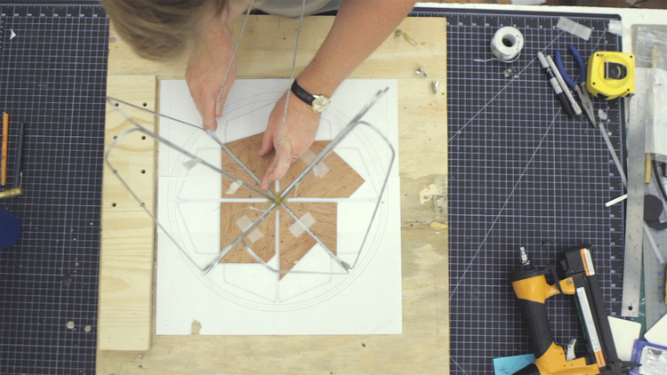 We used some cut wooden wedges to locate the wire properly for soldering.