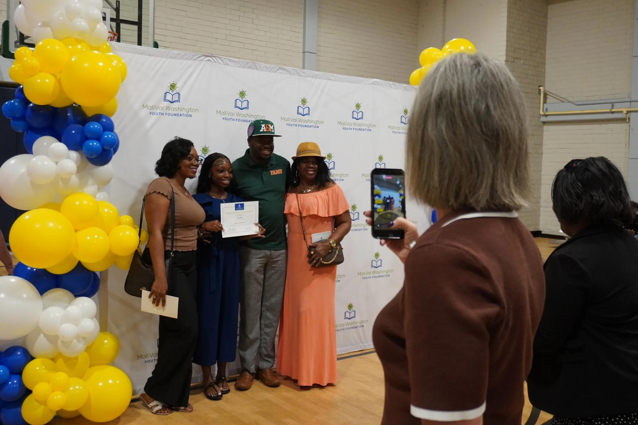 Ashlei smiles with award (1).png