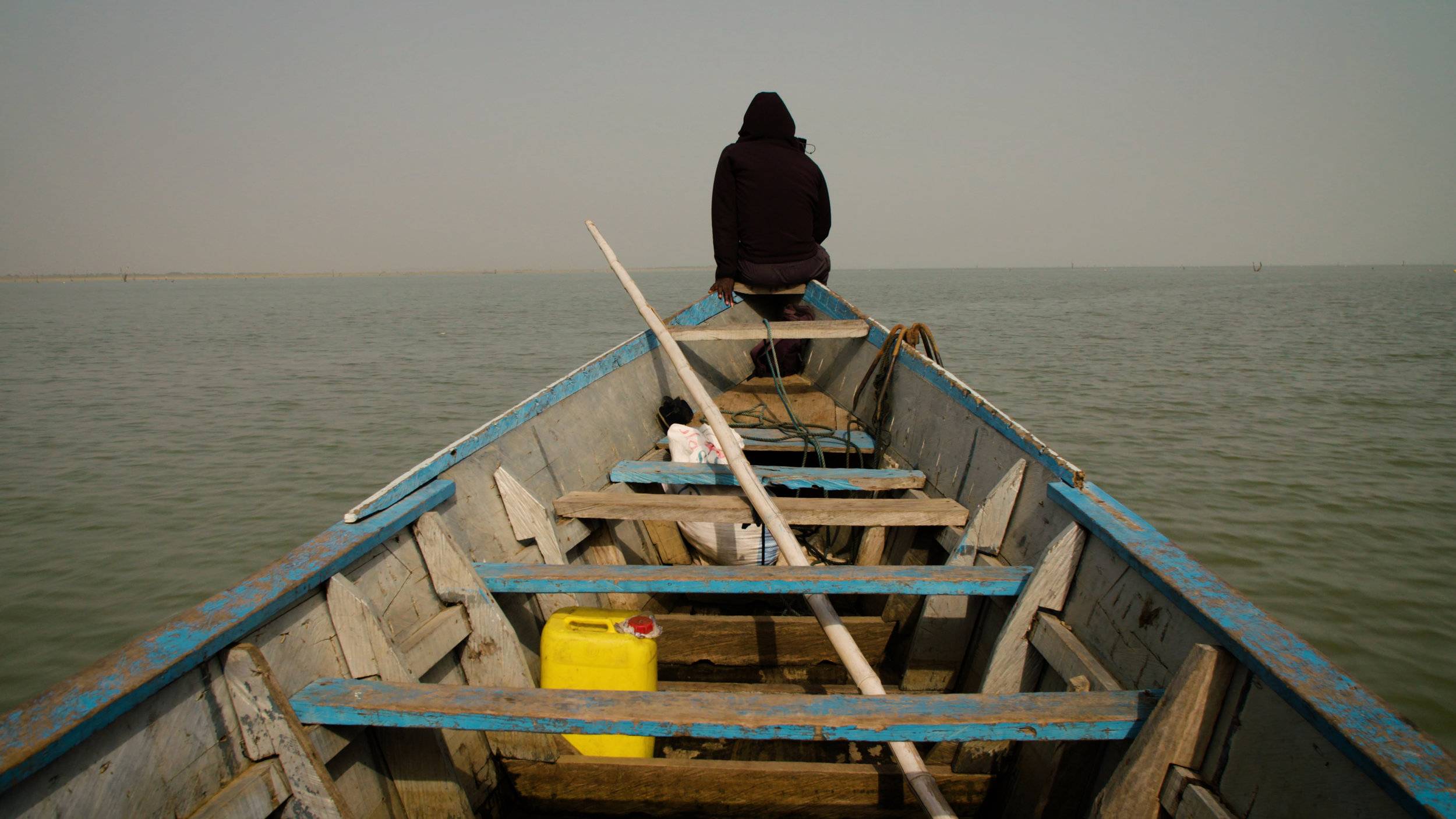 Kwame on the bow of rescue boat.jpg