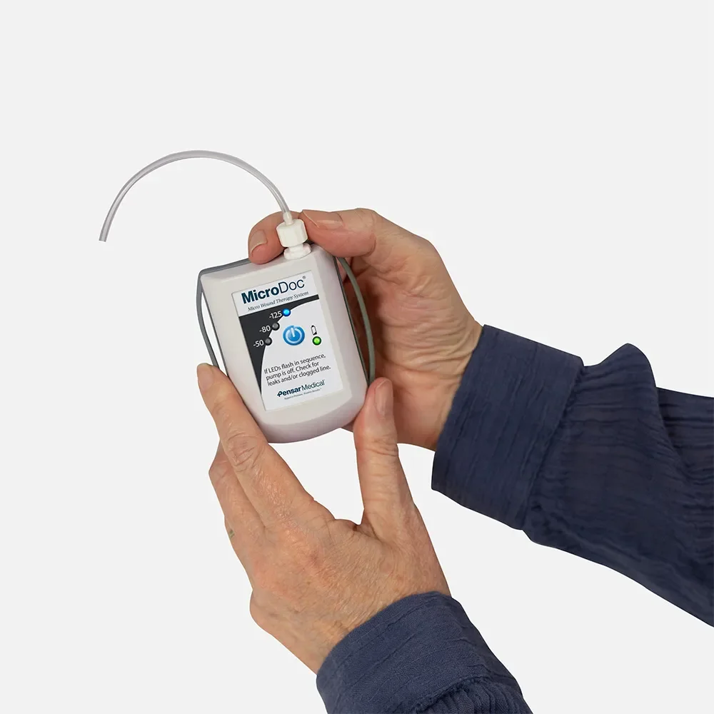 MicroDoc portable wound vac held in one hand