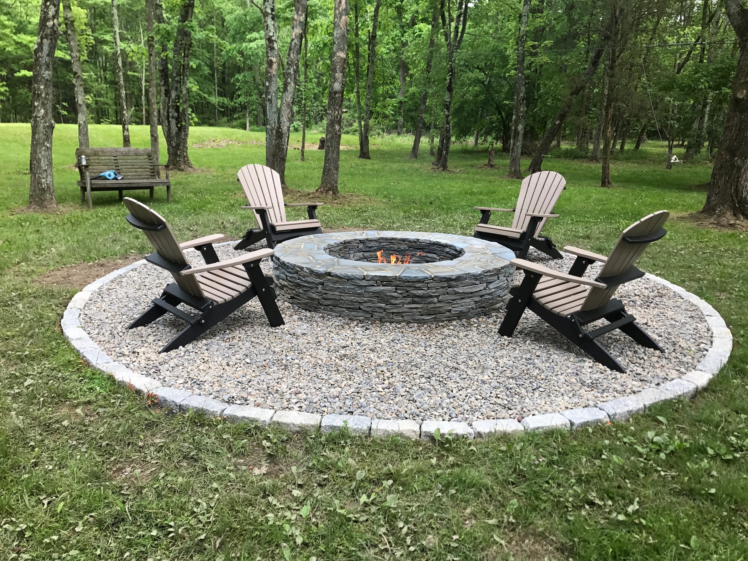 Once we had the Belgian block and river jack in place, we had a steady foundation to add some seating around the fire pit. We found the perfect poly wood chairs right around the corner! We purchased the chairs from Country Wood Crafters at their Rice's Market location. We think that the chairs really complete the fire pit area and love how the two-tone colors are a little different than what you would expect to see with a traditional Adirondak style chair.