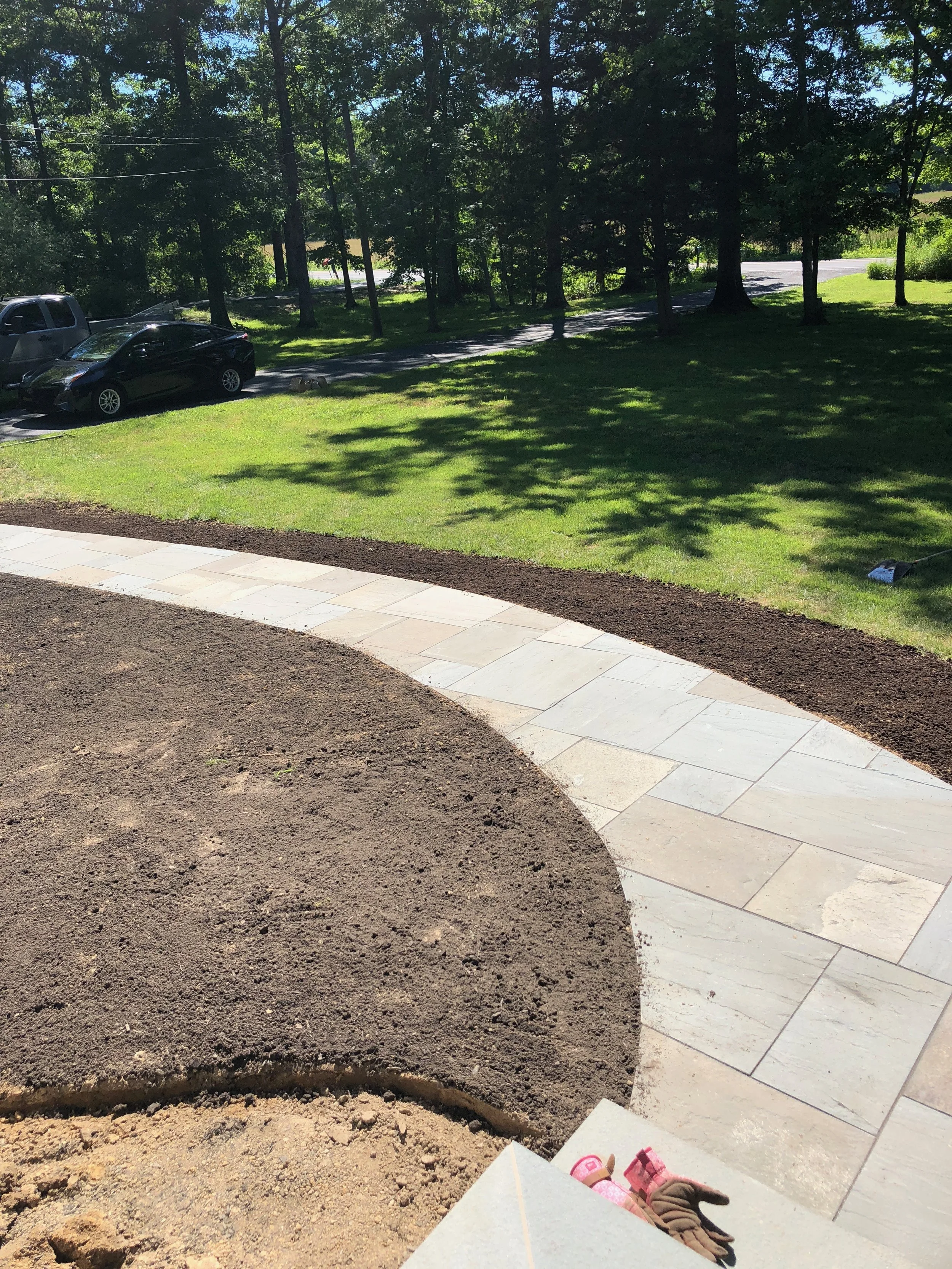 After the walkway was complete, the final step was grading the lawn. We added topsoil and planted grass seed so the walkway would blend seamlessly into the existing lawn.