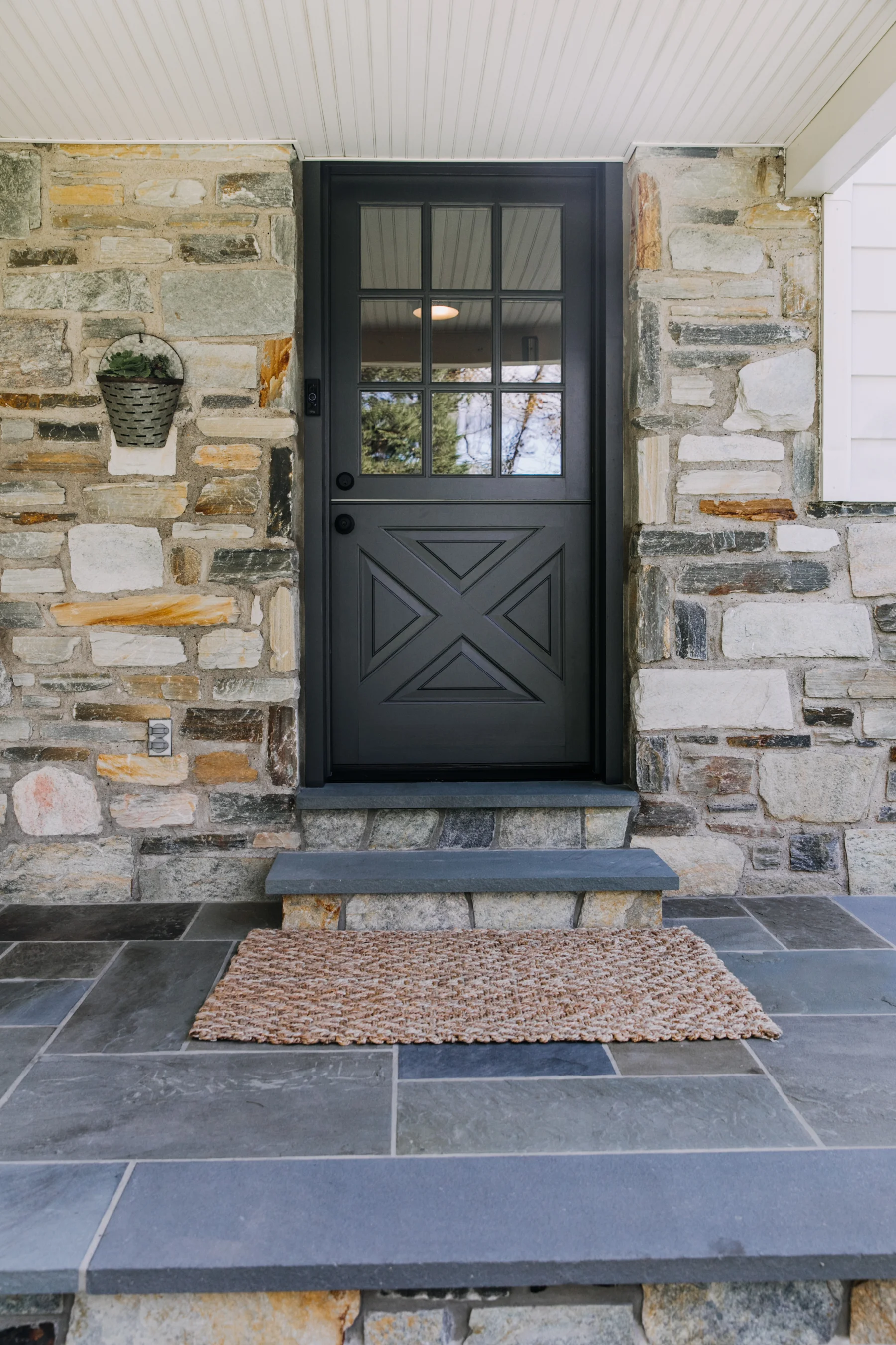 Fast forward to October! We ordered a dutch door from Niece Lumber . We then painted the door to match the shutters and had it installed by our friend Tim at New Hope Remodeling . Mike also updated the front door steps with the same stone from the house and with matching flagstone from the porch.