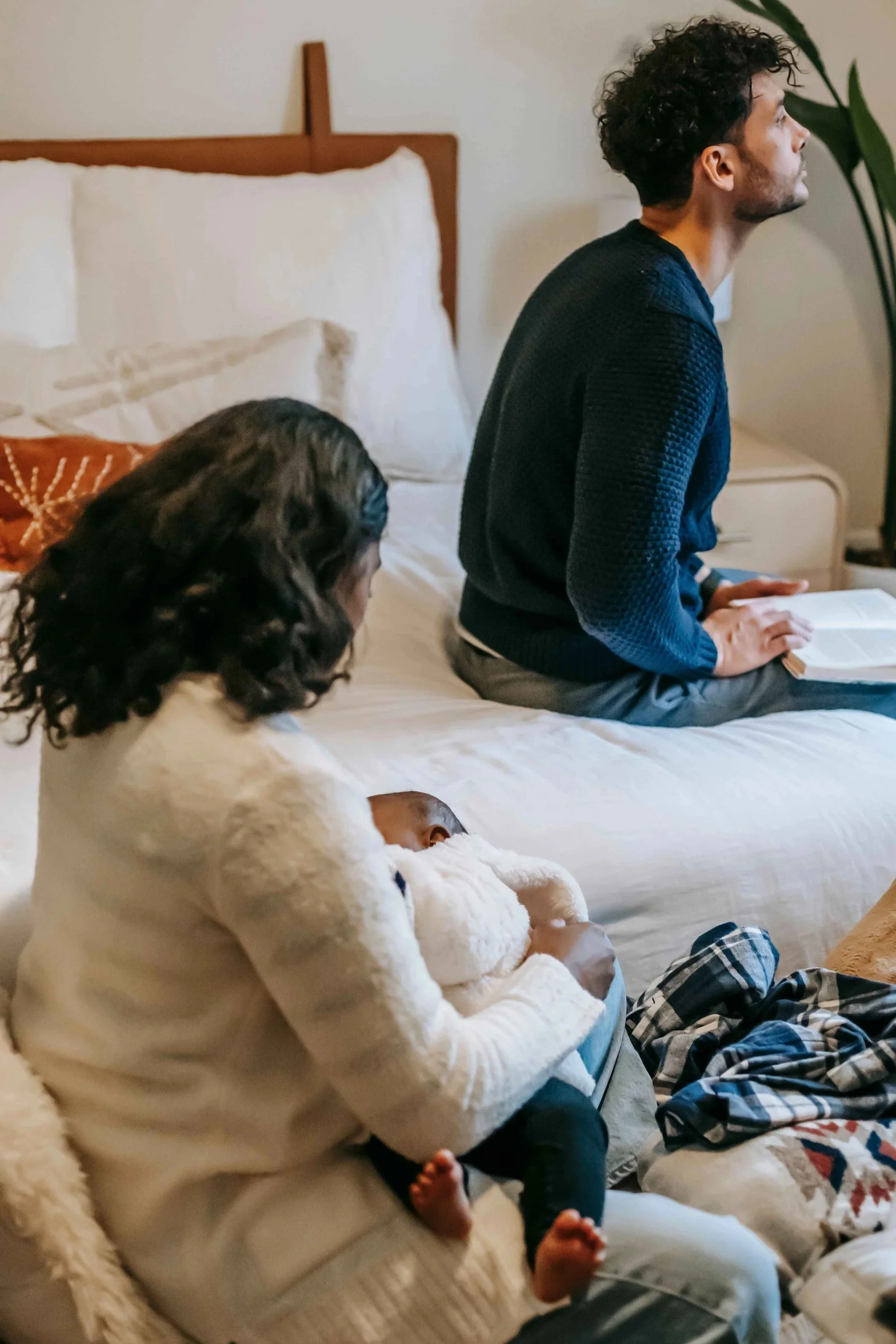 New mom taking care of baby while arguing with new dad, postpartum marriage strain Hoboken NJ therapist