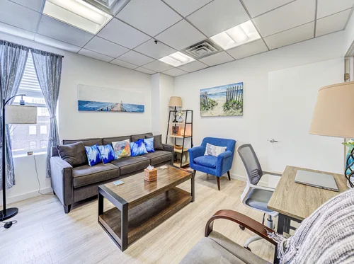 Therapy room with a sofa and desk at Anchor Therapy in Hoboken, NJ