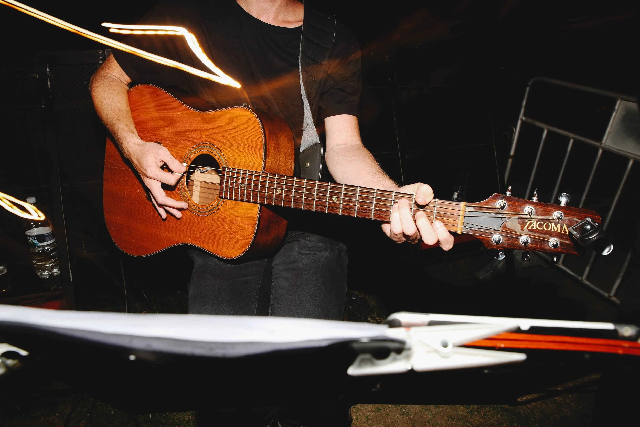 Close-up of a musician playing an acoustic guitar backstage, body dysmorphia counselor Hoboken NJ