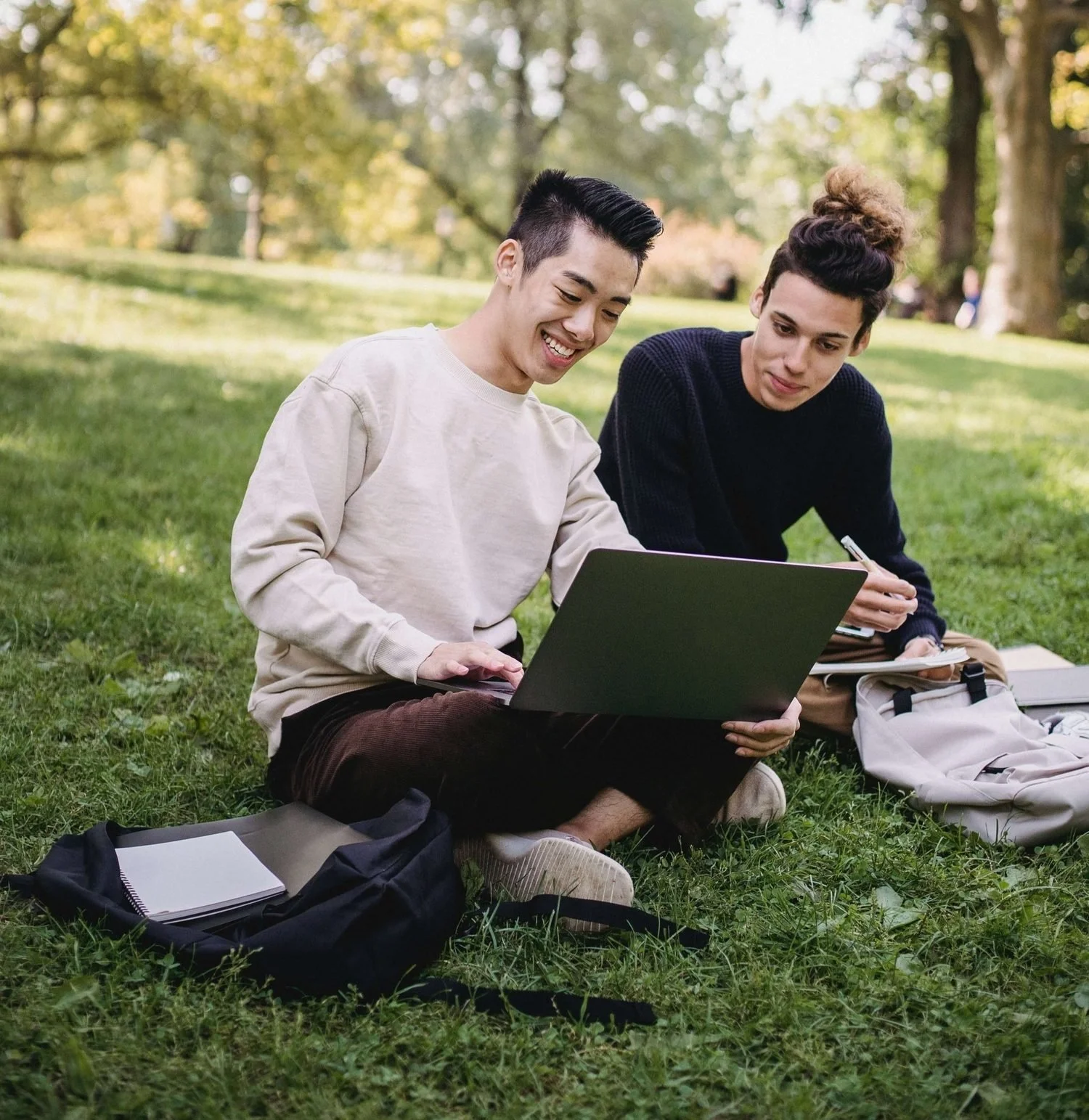 gay college couple doing work in park