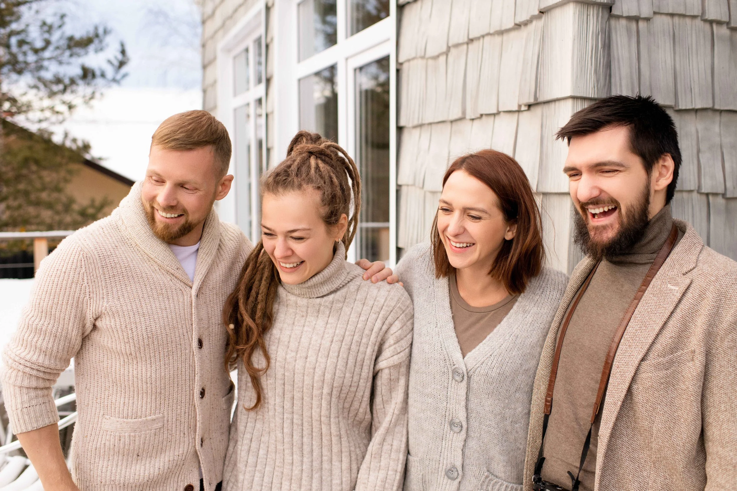 Four friends laughing together outside on a winter day, one-sided friendship, Hoboken NJ therapist