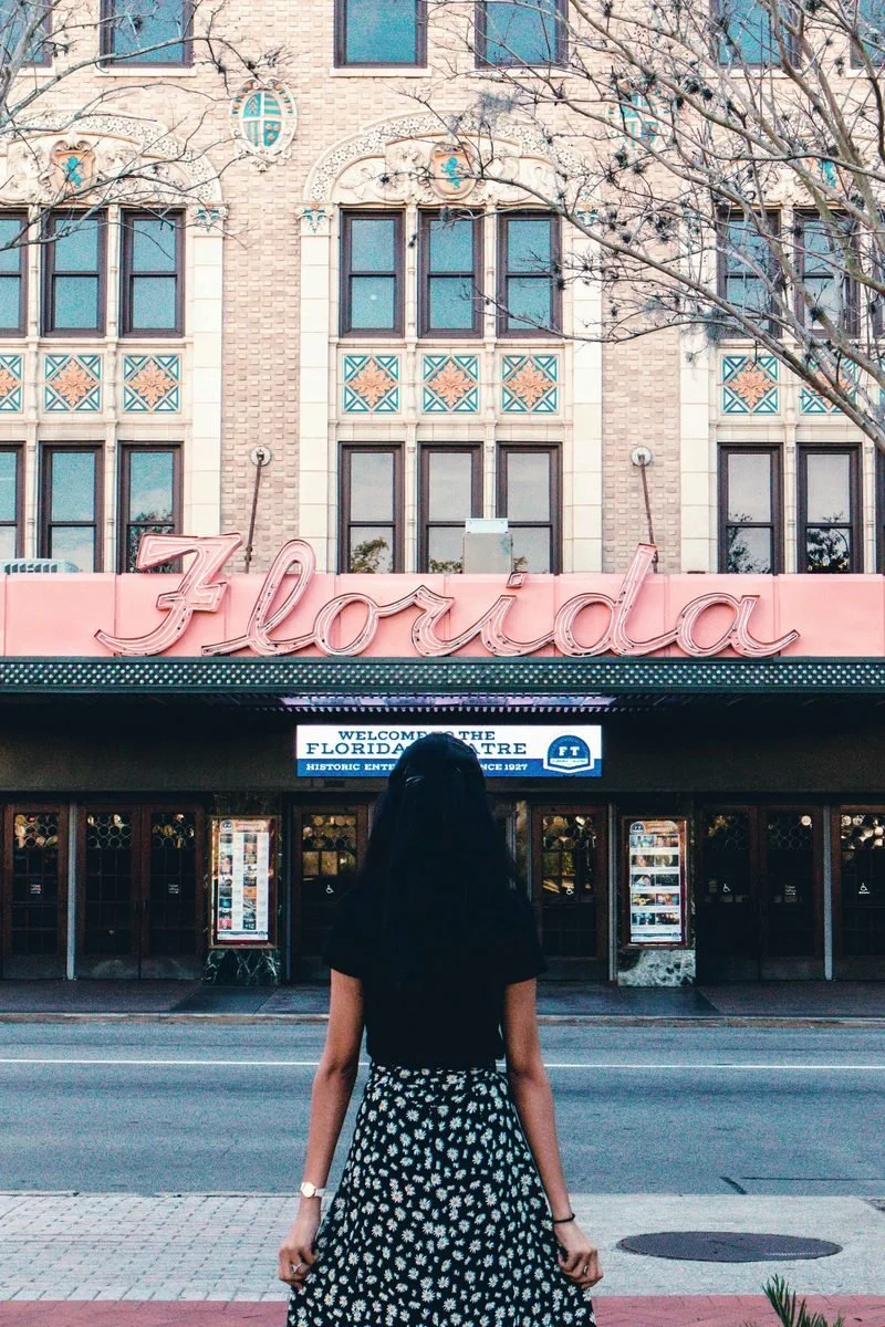 Woman standing in front of Florida theatre after attending Tallahassee counseling