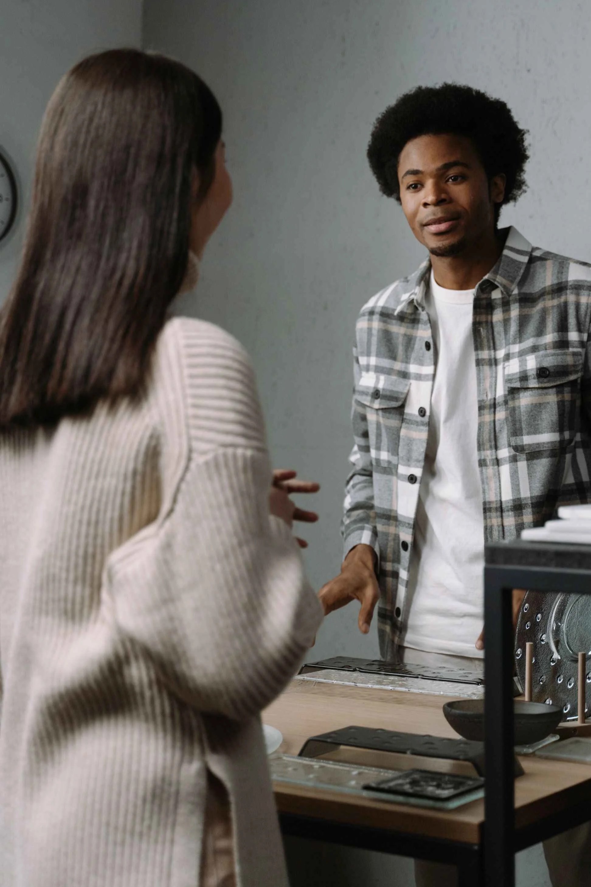 Man responding calmly while a woman gestures with visible emotion, an example of the mismatch in a conversation with a covert narcissist, Hoboken NJ therapist