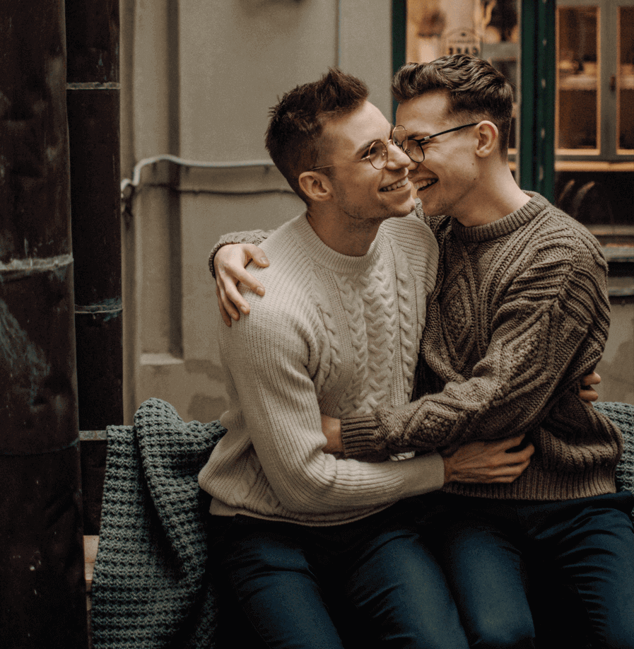 A same-sex male couple holding each other, supported by LGBTQ couples counseling at Anchor Therapy in Hoboken, NJ.