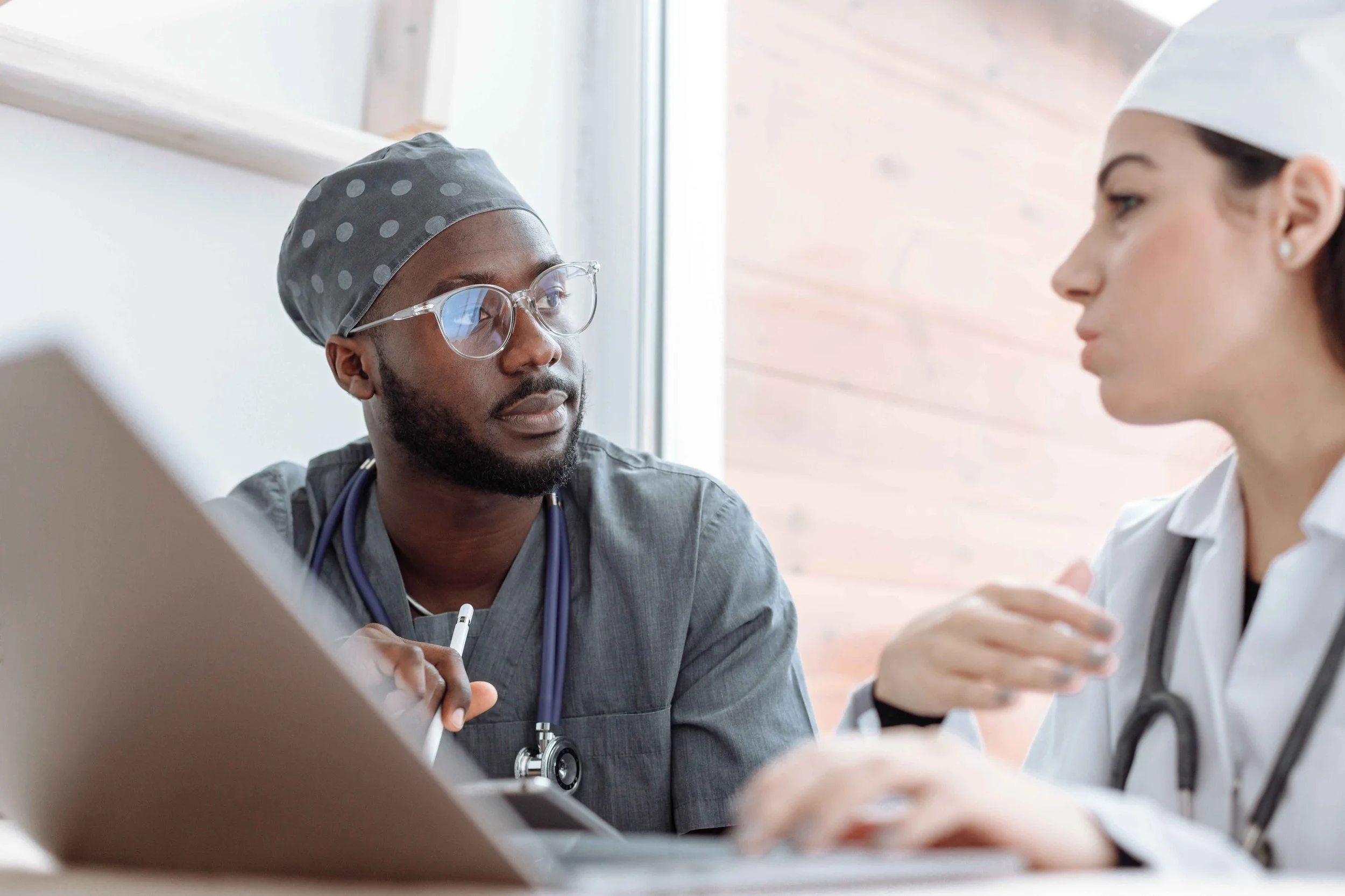 Doctor and nurse discussing patient care during a stressful shift, Hoboken NJ counselor