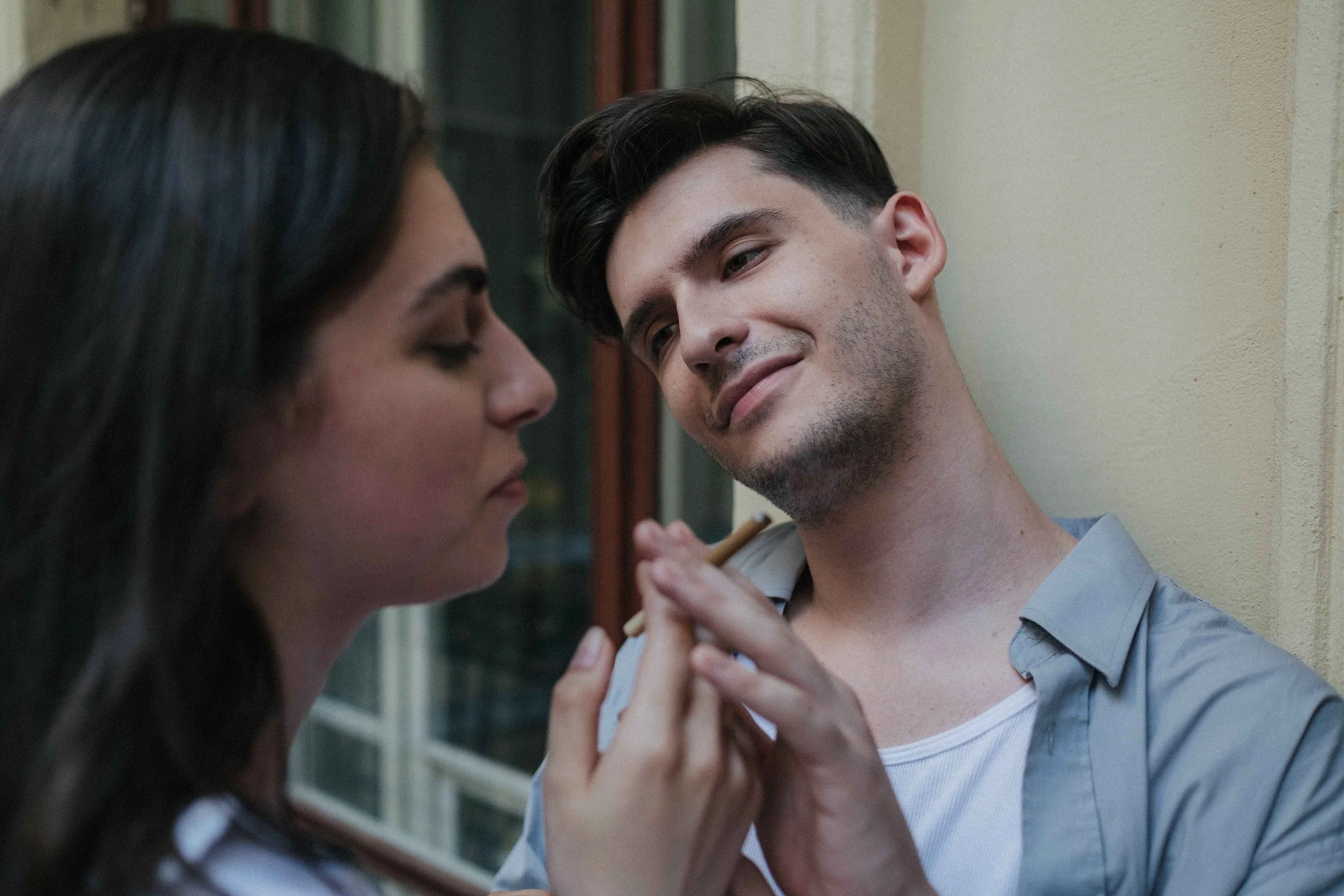 Man smiling smugly as a woman holds his hand, showing a narcissist hoovering an ex back in, Hoboken NJ counseling