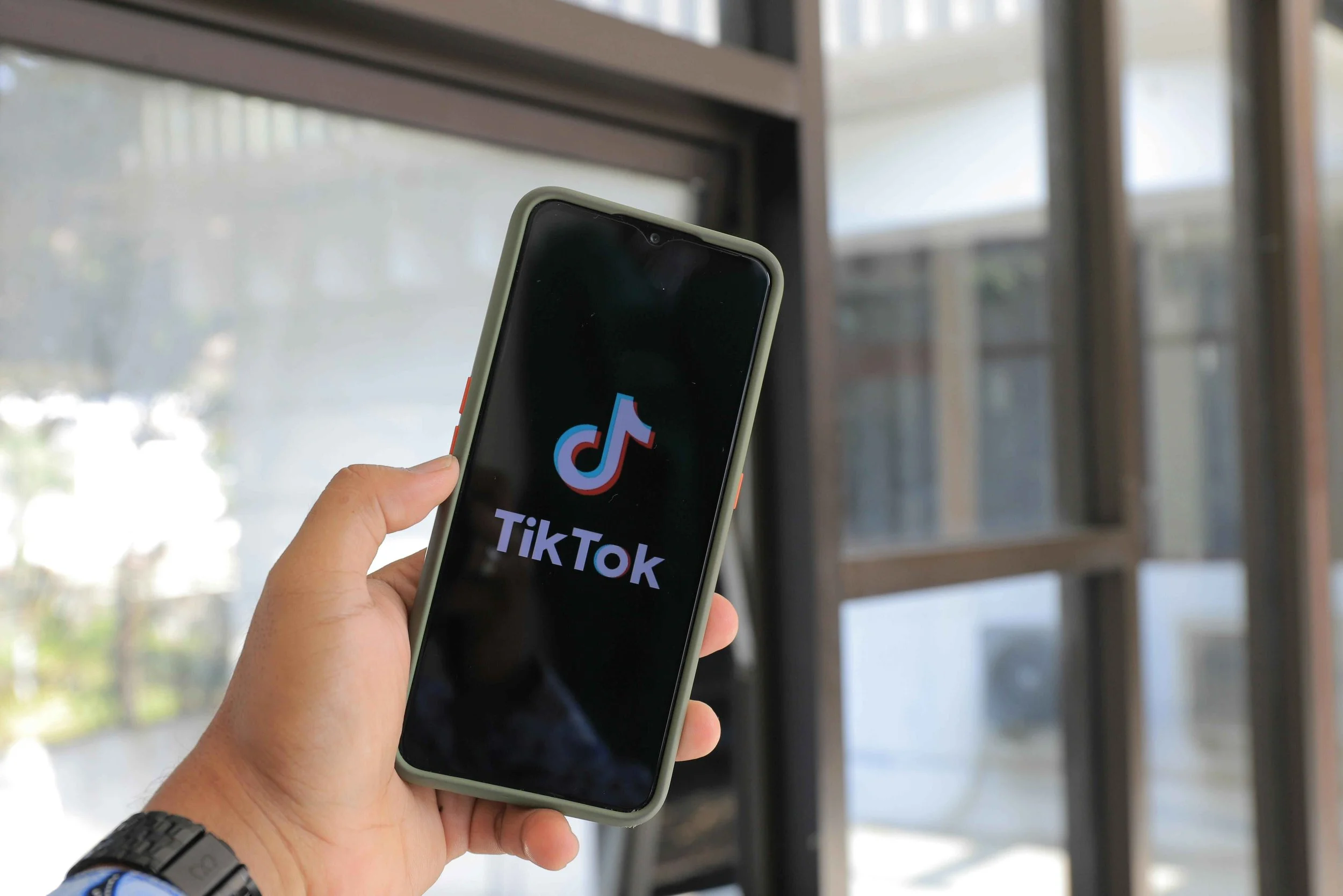 A person scrolling the TikTok app on their phone, social media anxiety and teen counseling services in New Jersey