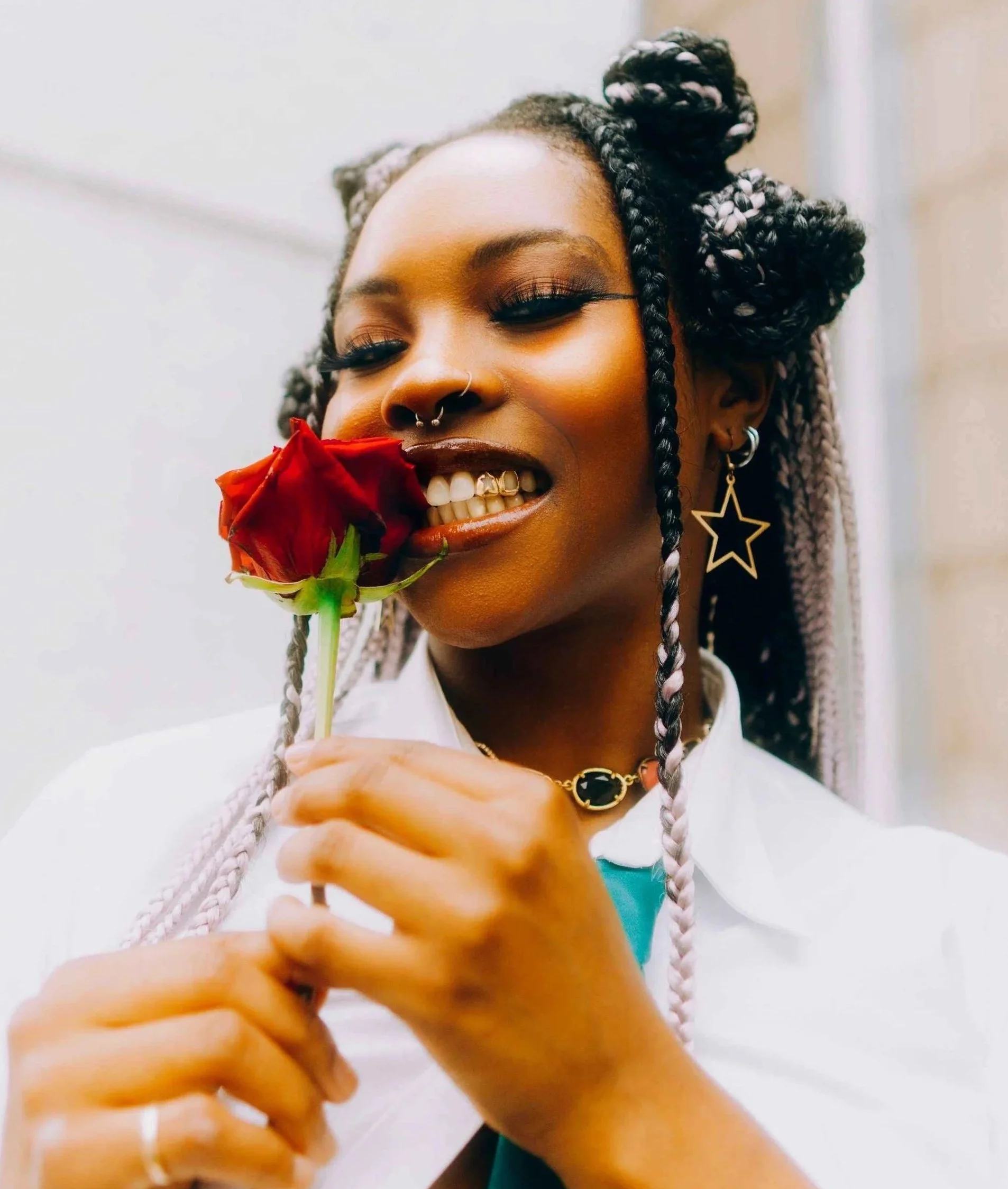 Hoboken teen smiling confidently while holding a rose, embracing her main character moment