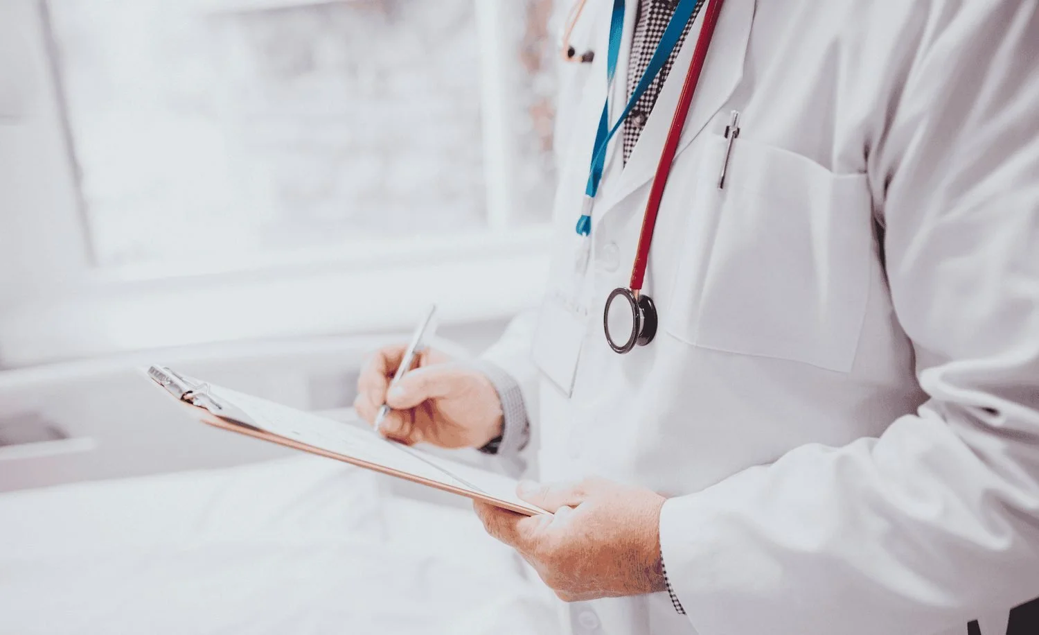 doctor writing chart notes and debating changing careers in nyc