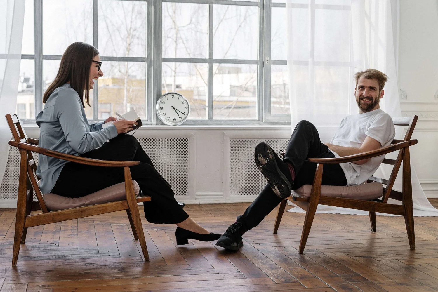 An adult therapist and client talking during an adult therapy session in Hoboken, NJ.