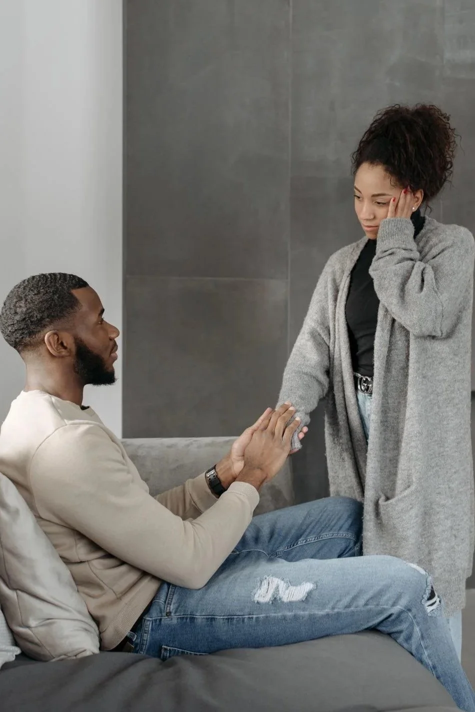 Woman looking troubled while her partner reaches for her hand, an example of reassurance seeking in moral OCD, Hoboken NJ therapist