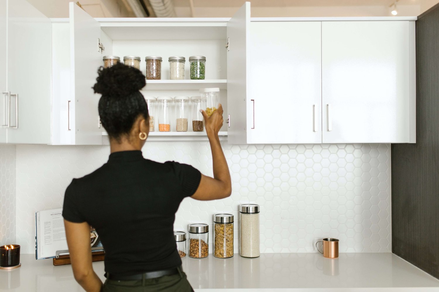 Woman arranging kitchen items in a precise order, an OCD symmetry compulsion