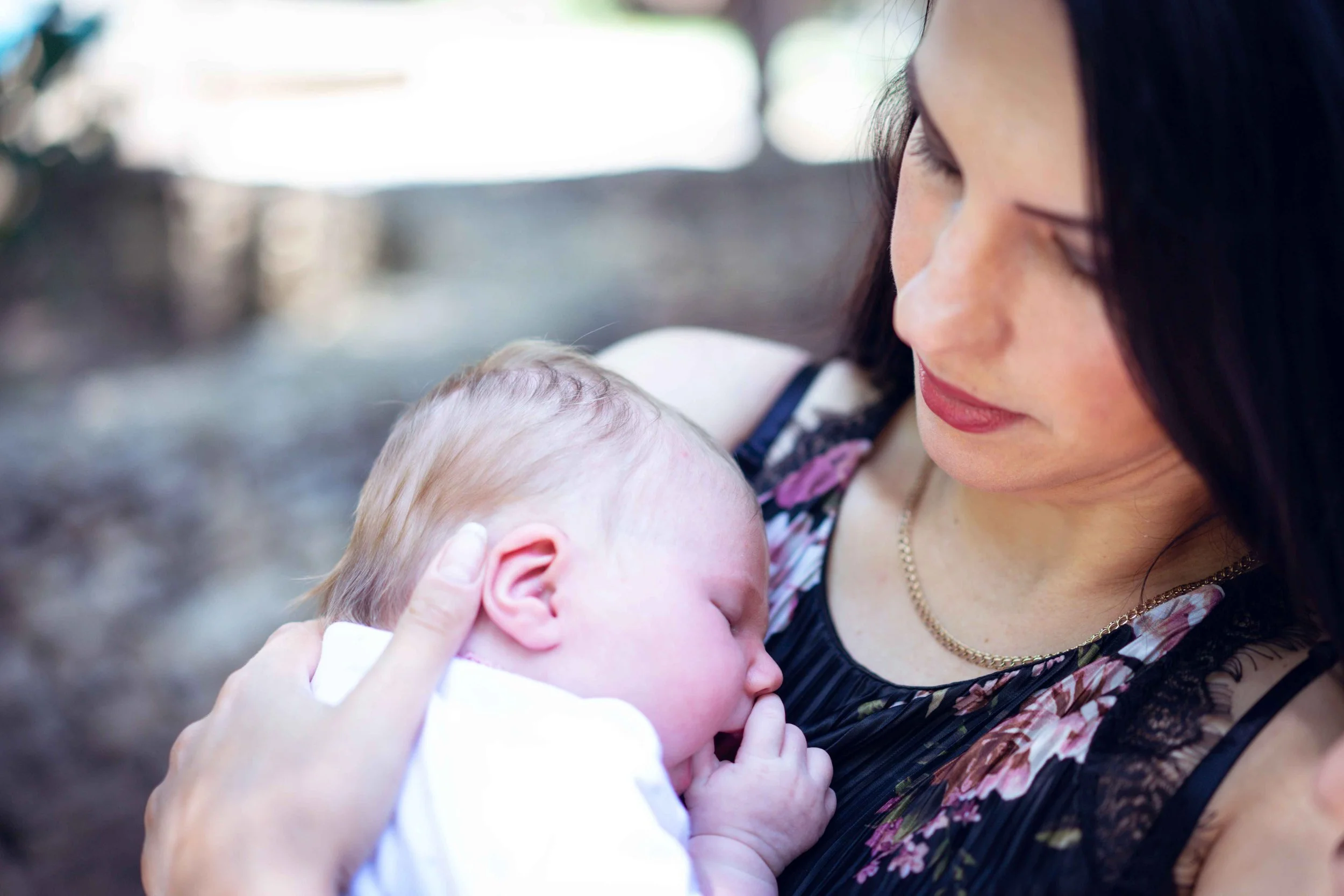 New mom holding her baby, postpartum counseling Hoboken NJ therapist