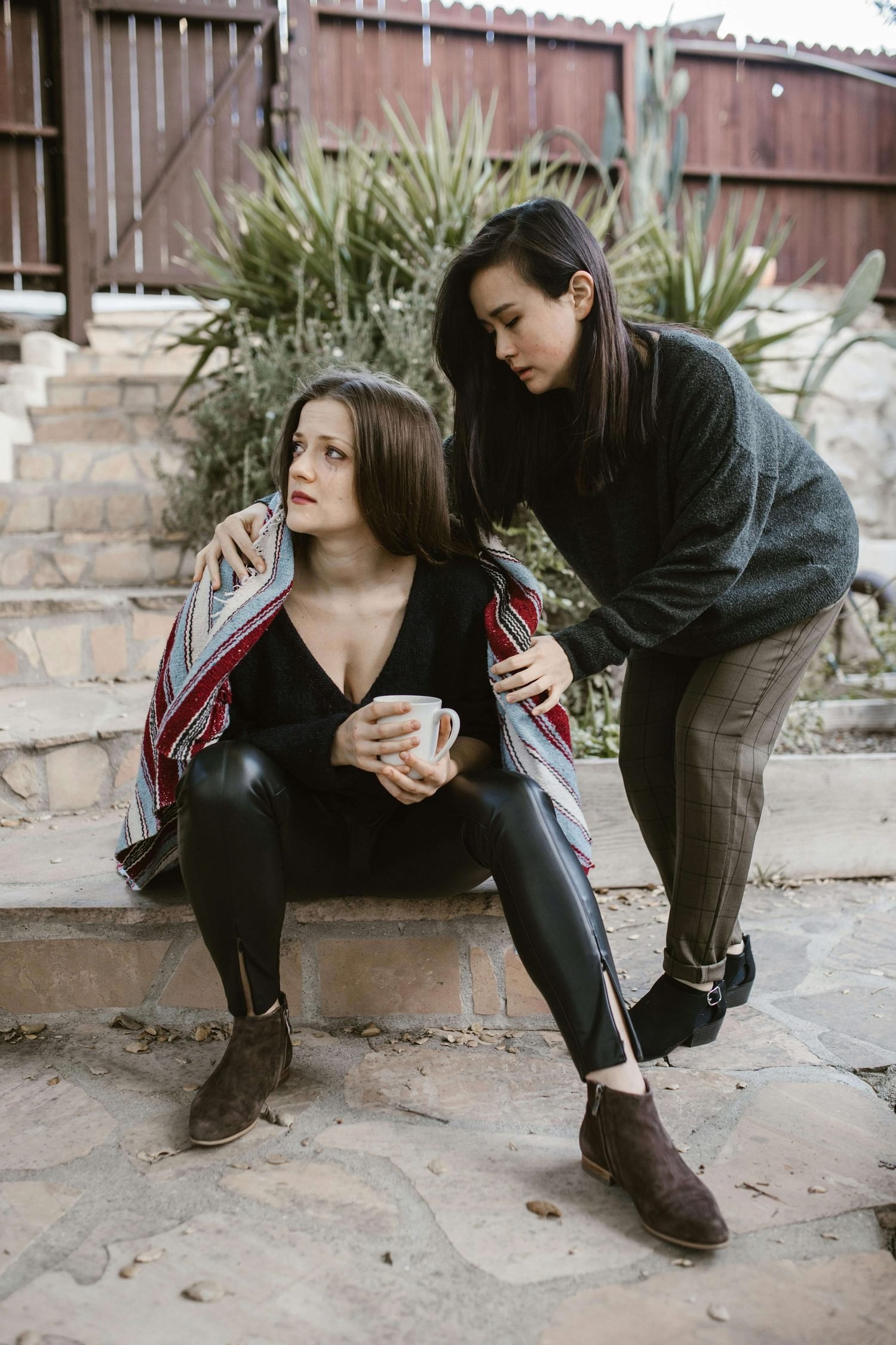 woman supporting another woman who is upset and terrified of rejection after therapy in nyc