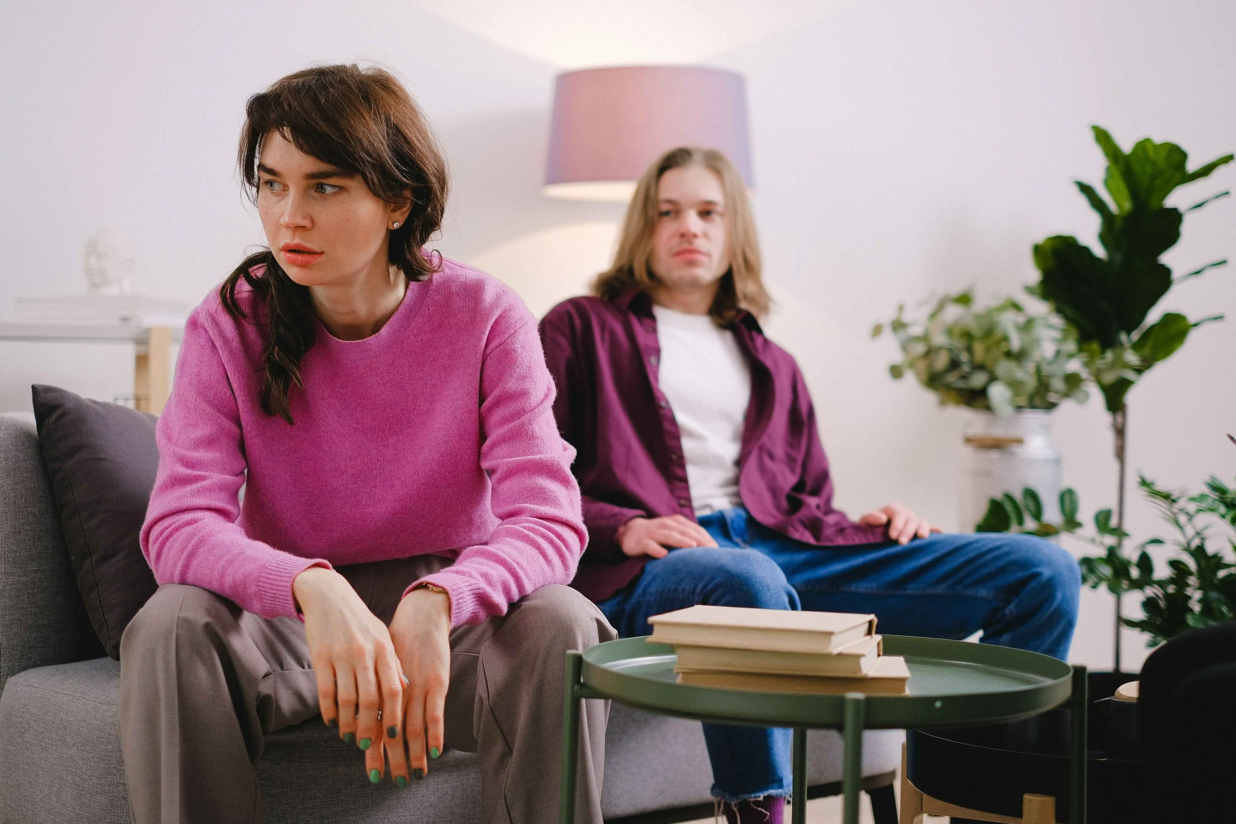 Hoboken couples therapist describes the silent treatment as a woman sits turned away from her partner on a couch