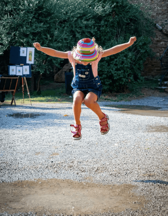 child-jumping-in-playground-over-puddle-and-has-anxiety-in-hoboken-nj