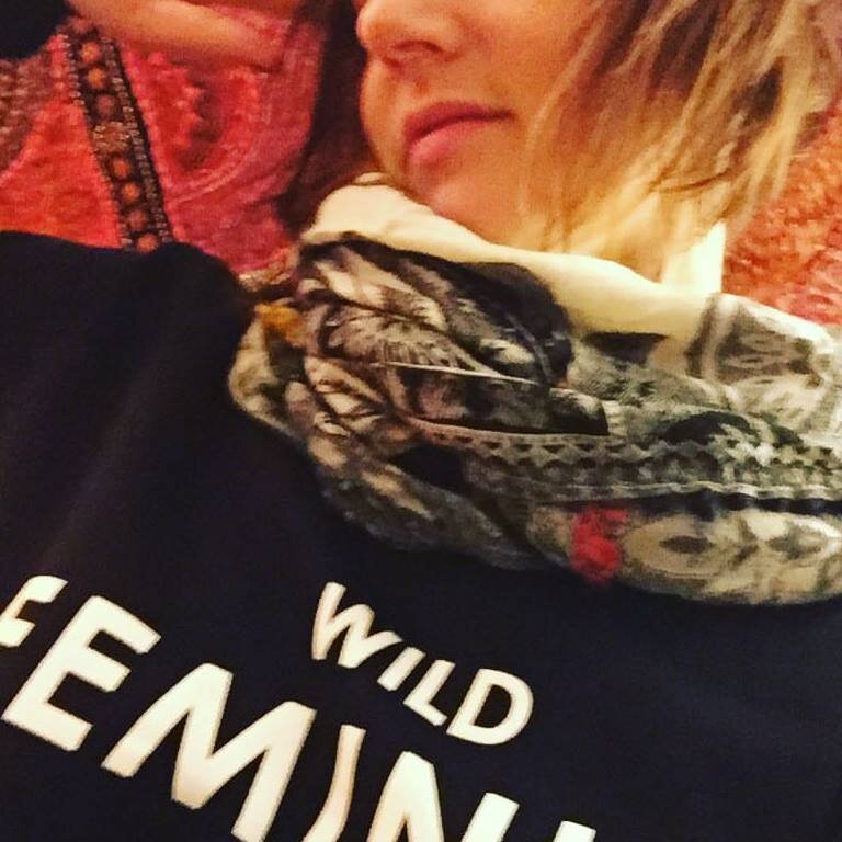  Photo of Heather wearing sweatshirt that reads Wild Feminist 