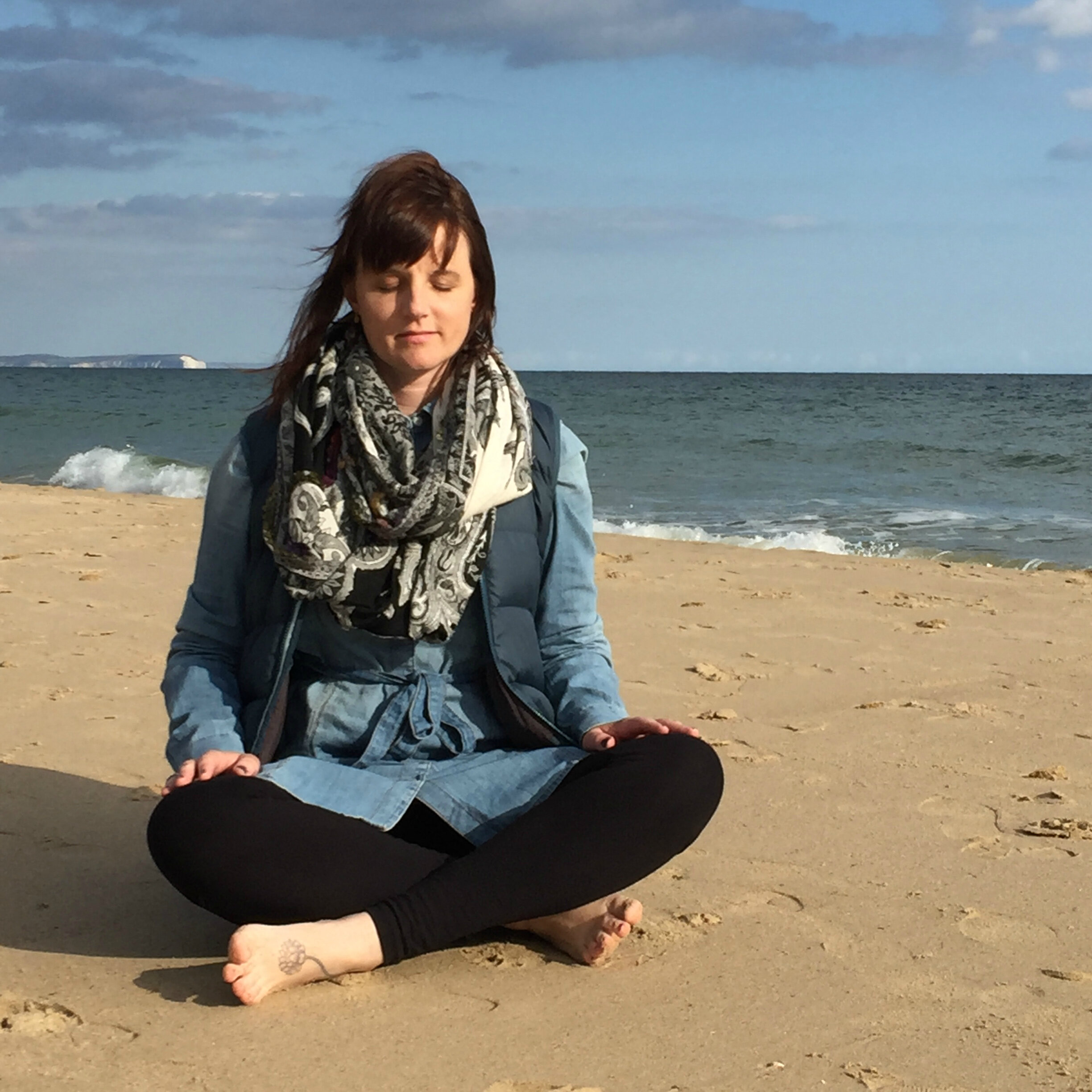  Photo of Heather meditating on beach 