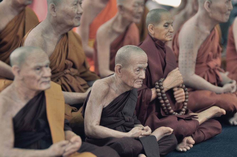 Monks meditating with their eyes open
