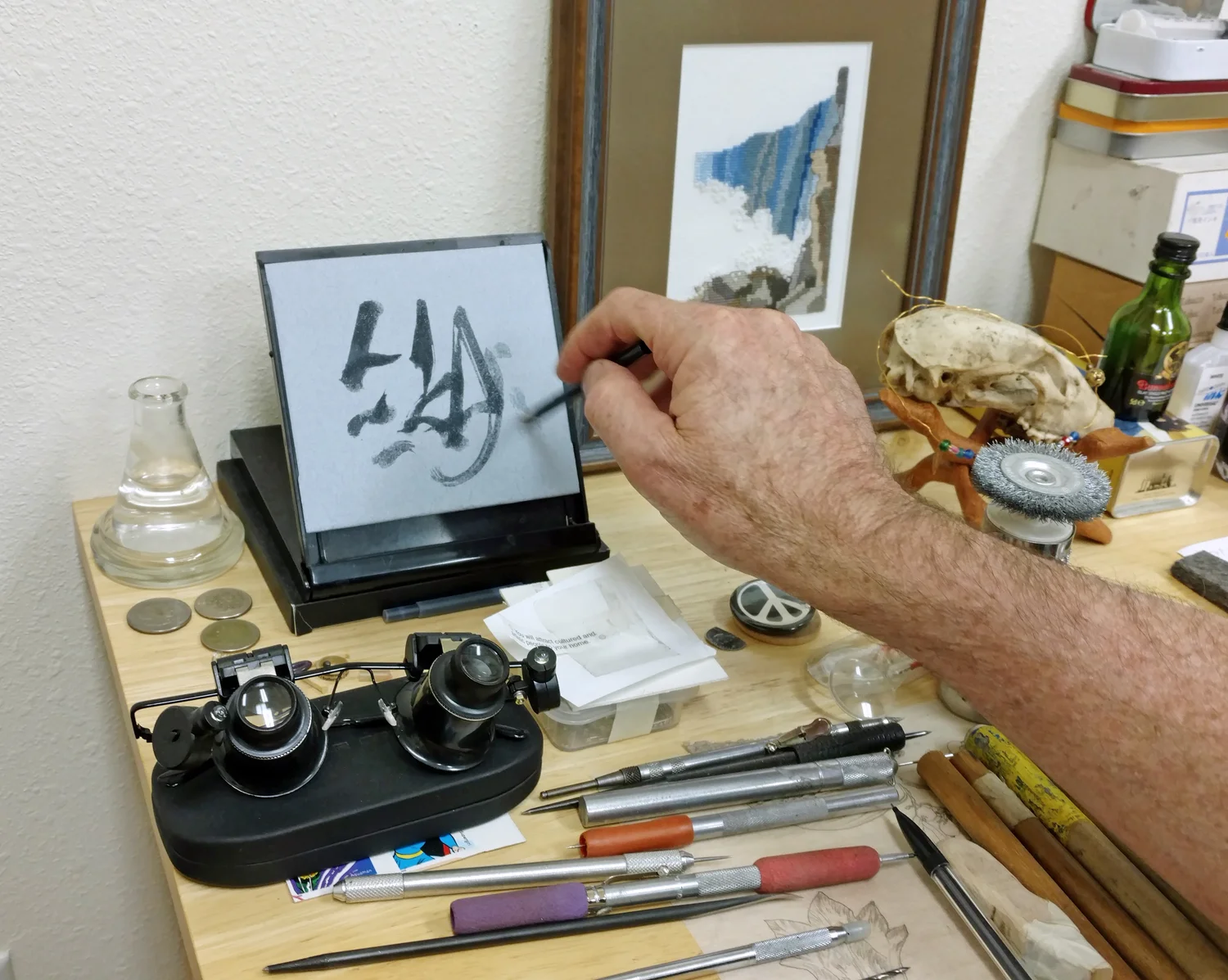 Johntimothy at an interlude with moments of play on the tiny Buddha Board, a reusable calligraphy pad.