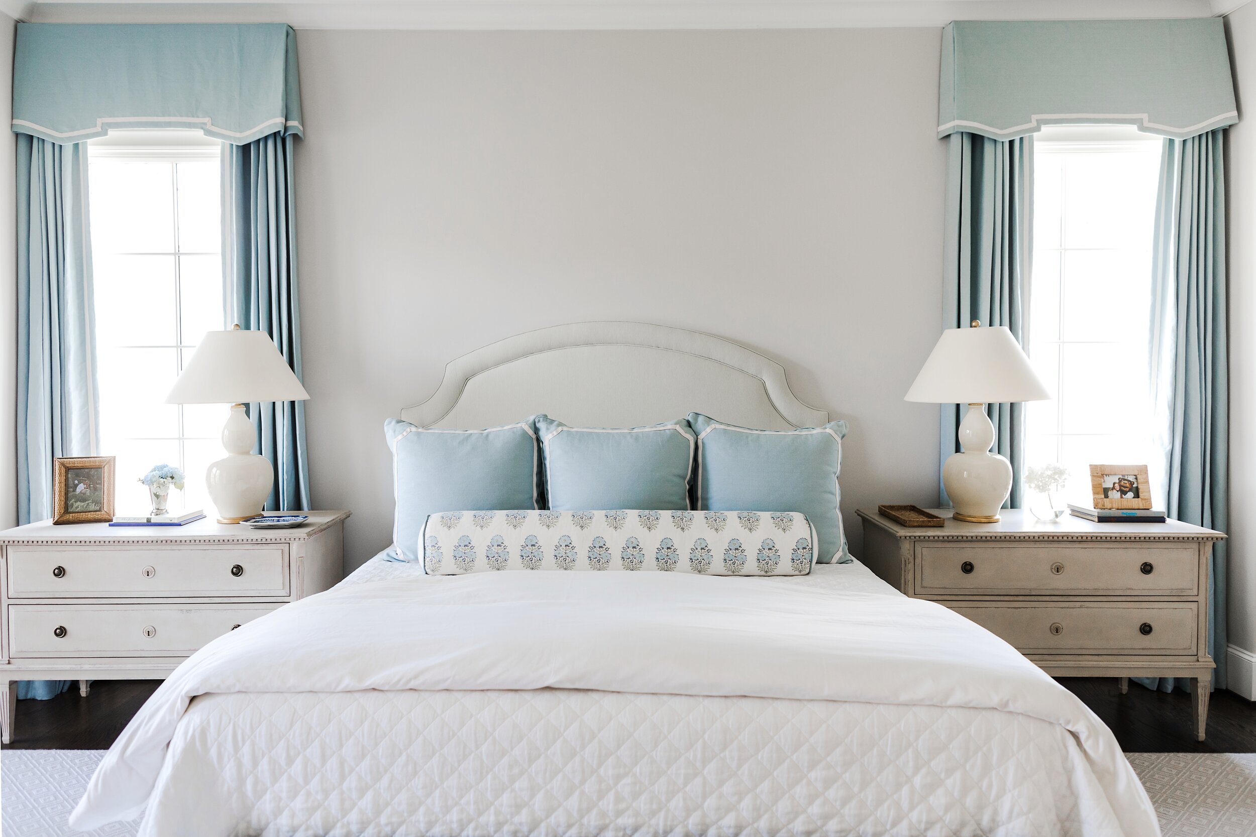 Master Bedroom with White Bed Spreads and Blue Accent Pillows and Curtains