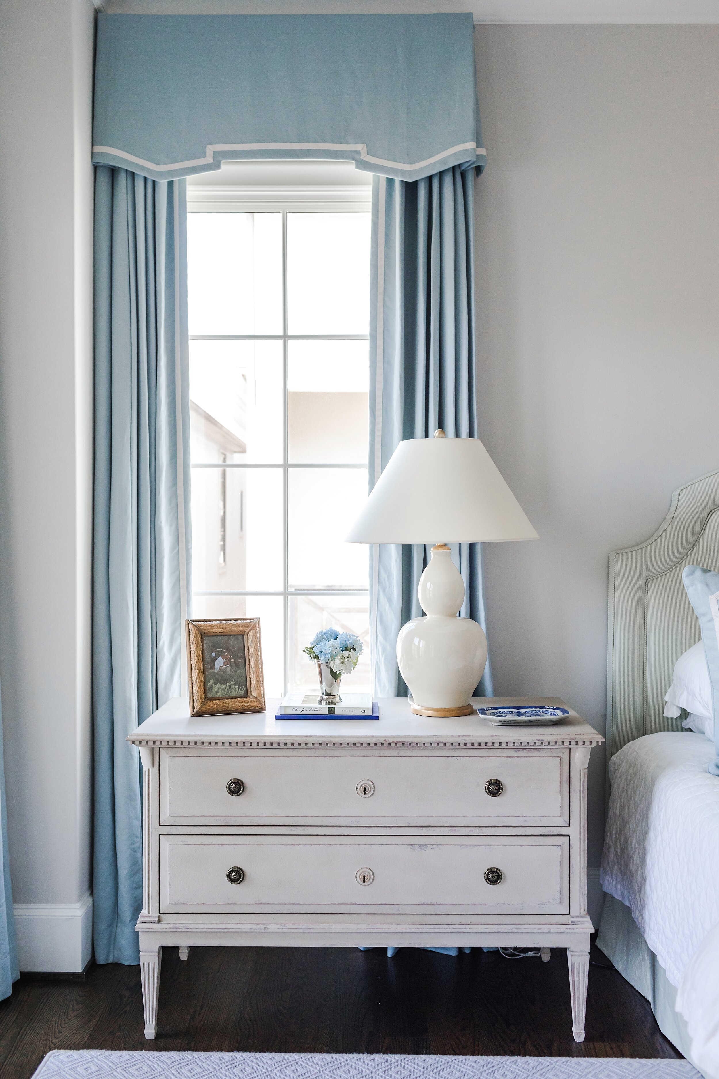 Master Bedroom White Wooden Nightside Drawers with Blue Curtains