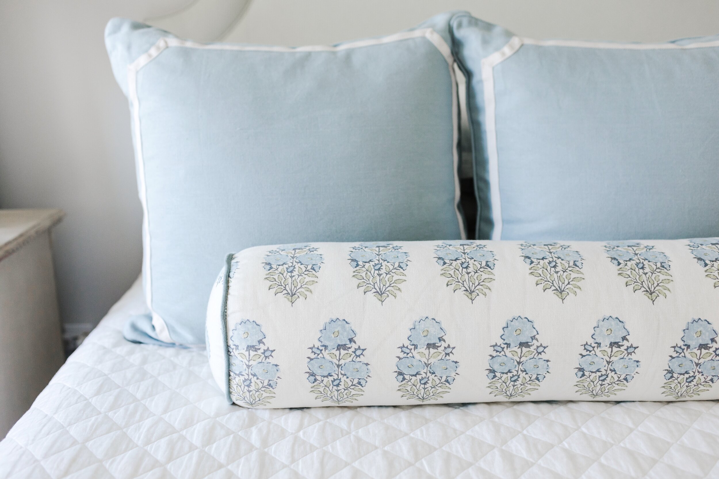 King Bed with White Comforter and Blue Accent Pillows