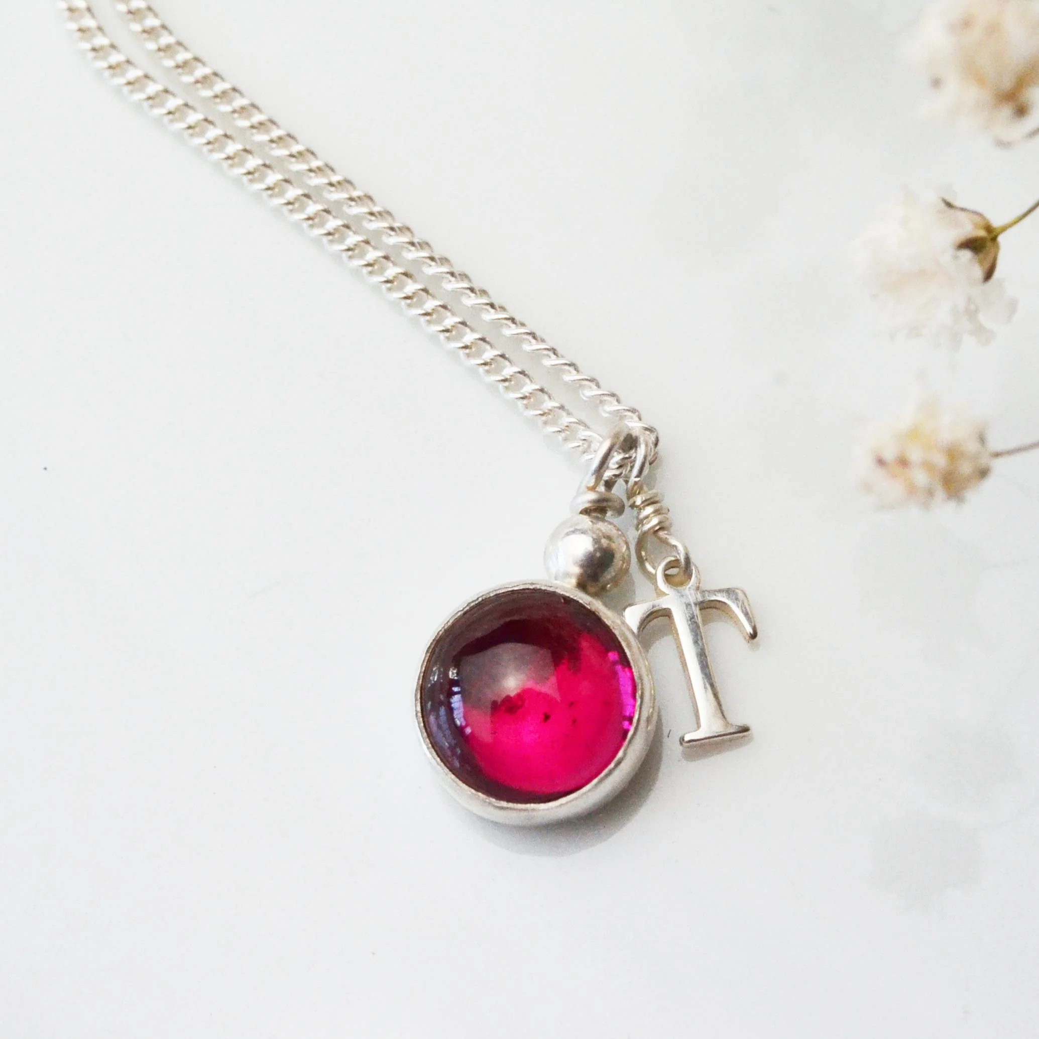 ruby cabochon pendant with letter.jpg
