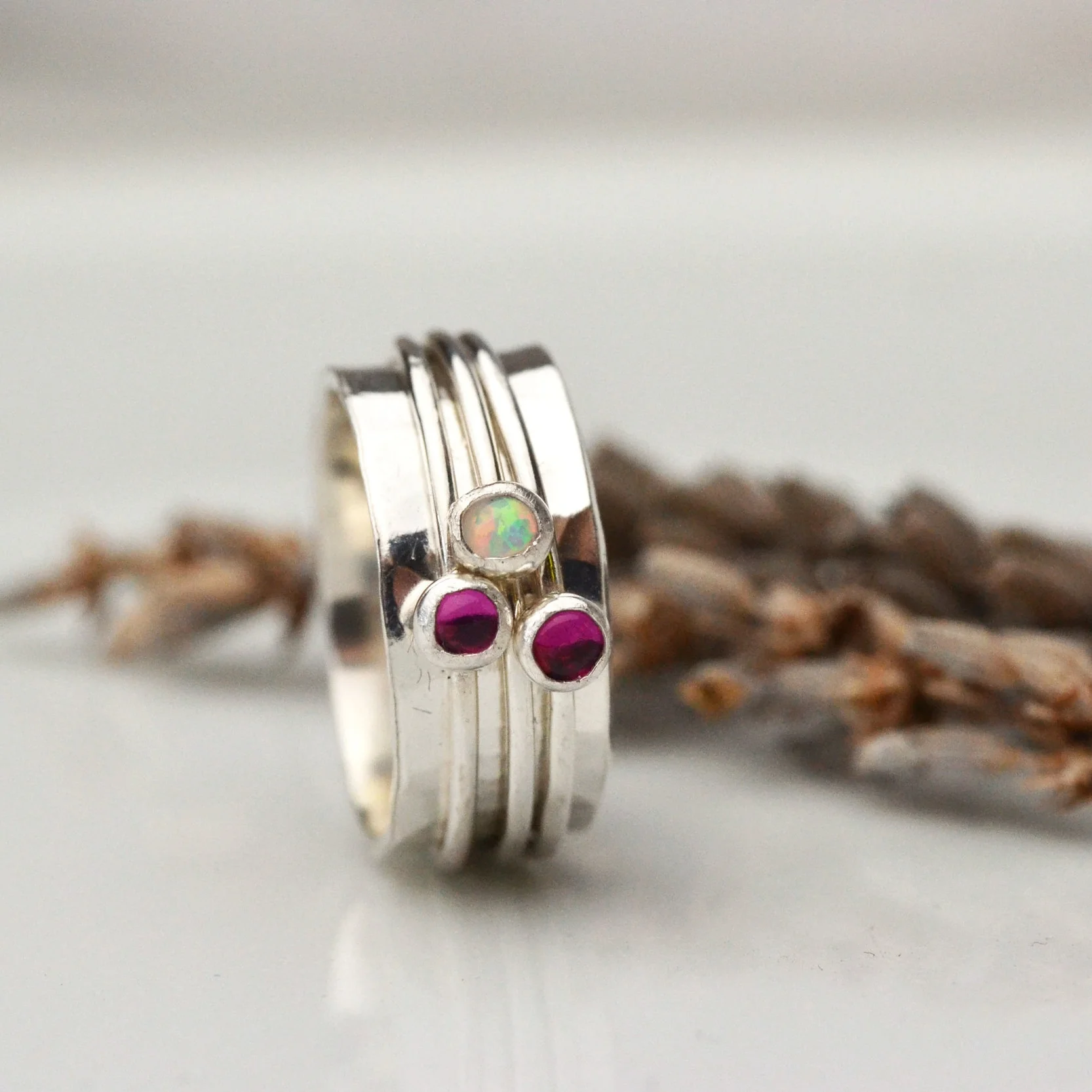 spinner ring ruby opal three stone.jpg