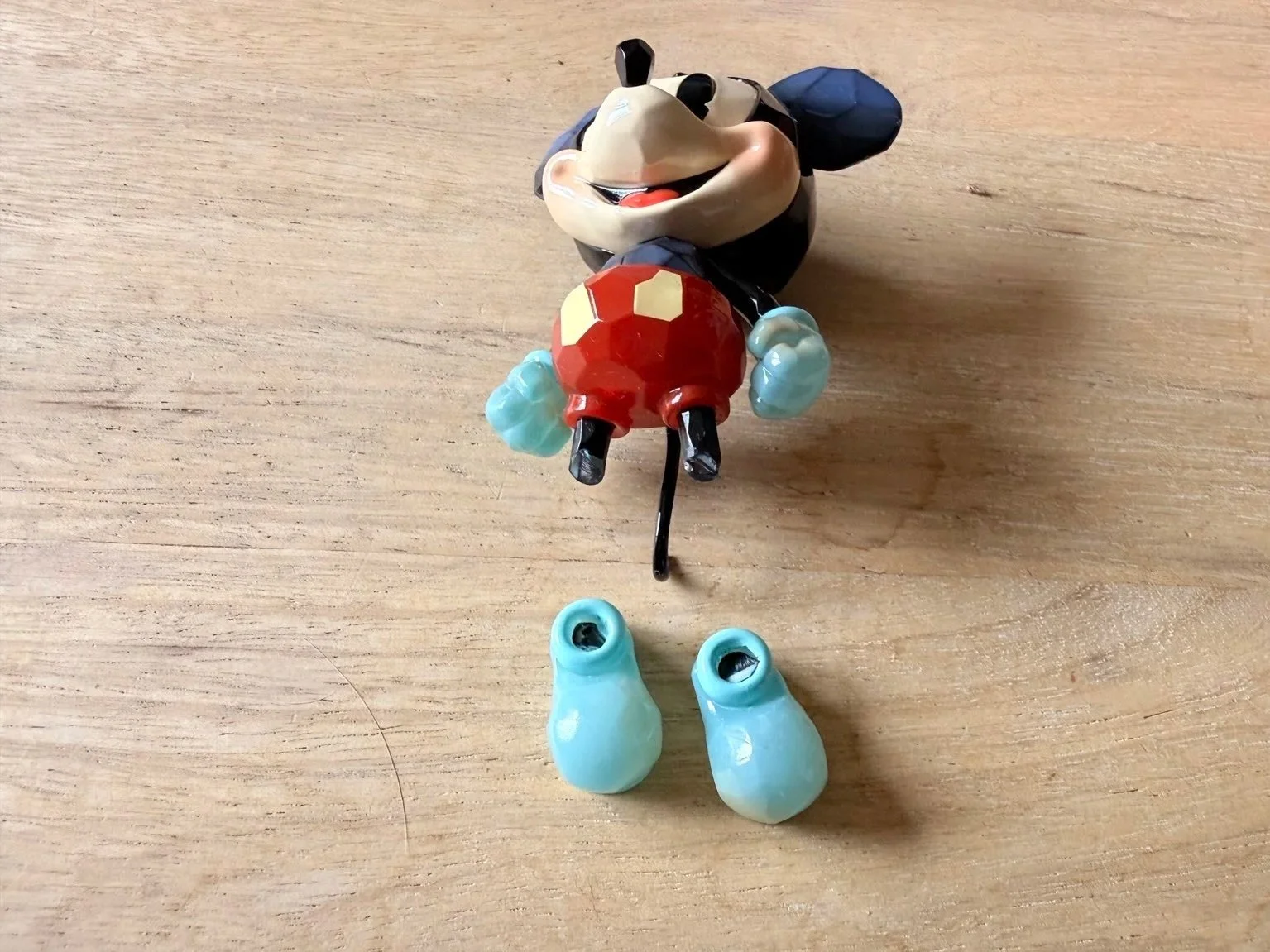 Broken POP MART Mickey figure with detached parts after unboxing