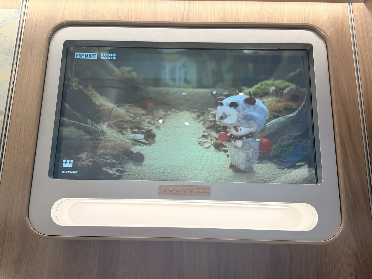  POP MART in-store digital screen showing animated character content 