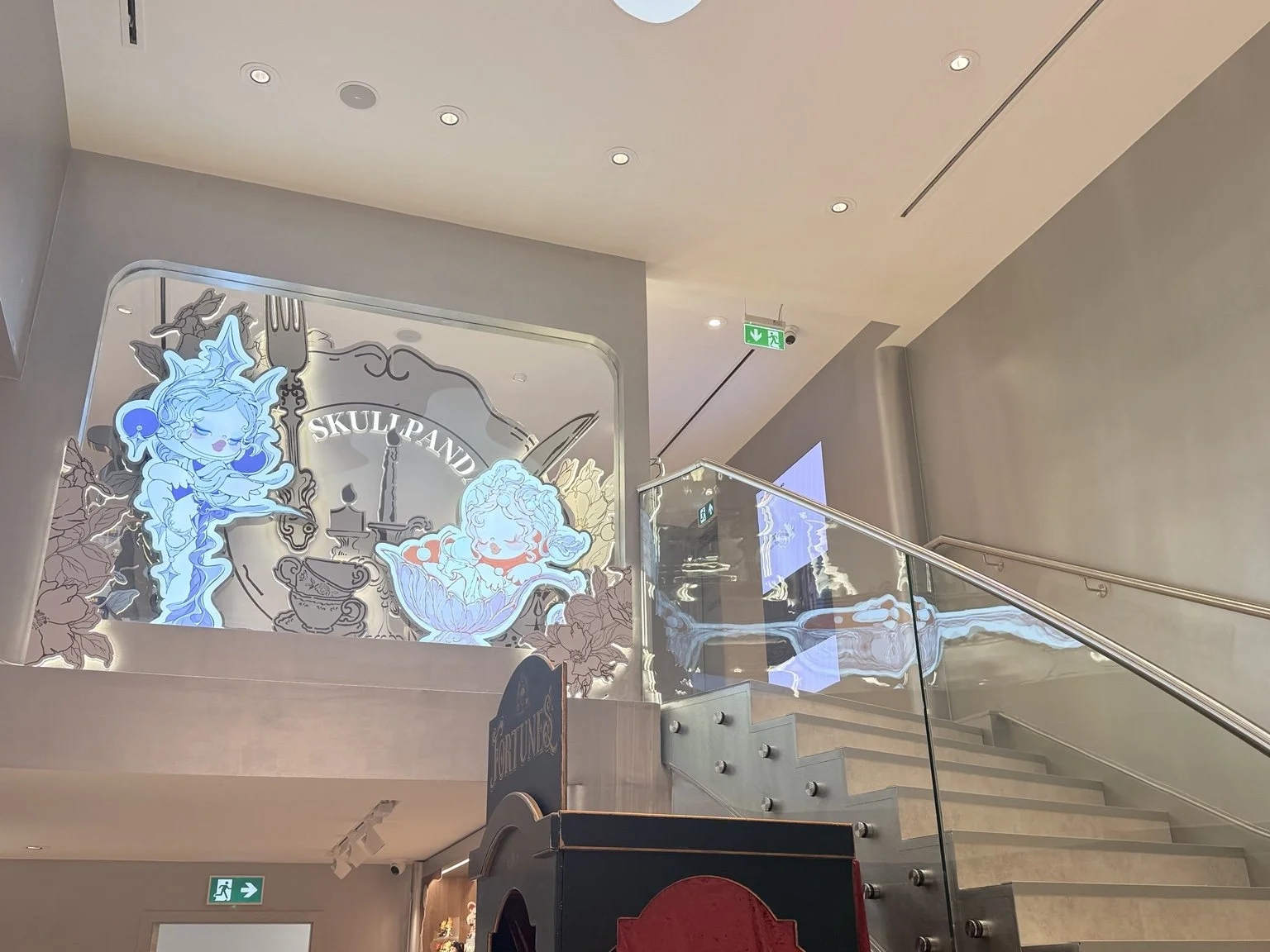  POP MART London staircase featuring Skullpanda artwork and immersive store design   