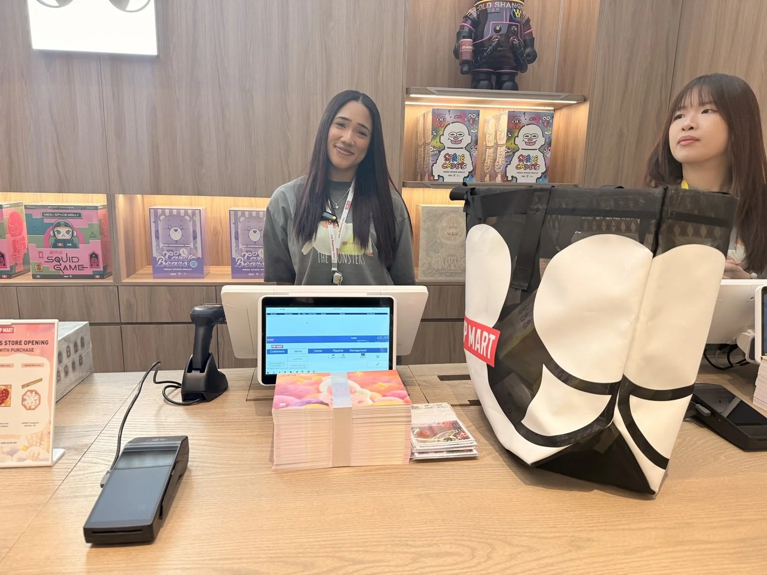 POP MART London store cashier desk with friendly staff and customer purchase bag