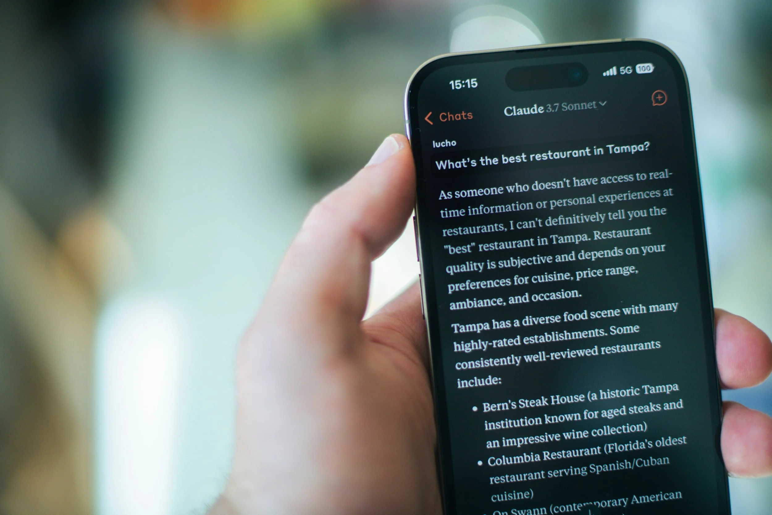 Close-up of a smartphone displaying a Claude AI chat interface with a user asking for restaurant recommendations, symbolising the growing role of generative AI in everyday decisions.