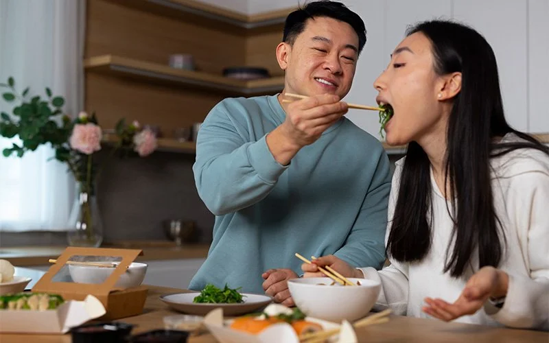 Couple sharing a meal to foster deeper emotional intimacy.