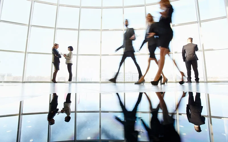Blurred people moving past reflecting the complexity of life's pacing.