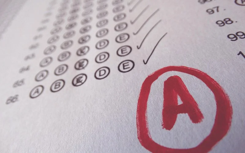 Exam paper with an A grade showing signs of perfectionism.