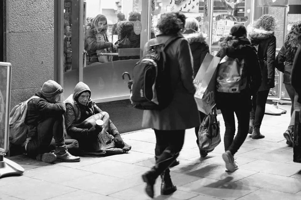 Photo-of-David-Johnston-from-OutsideIn-sitting-on-the-streets-talking-someone-who-is-homeless.jpg
