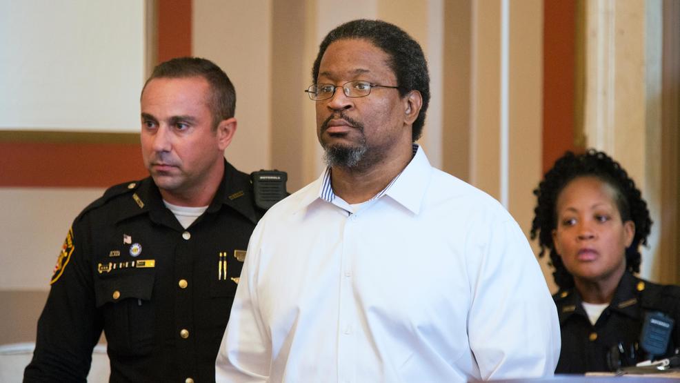 Kirkland being lead during one of his many court appearances