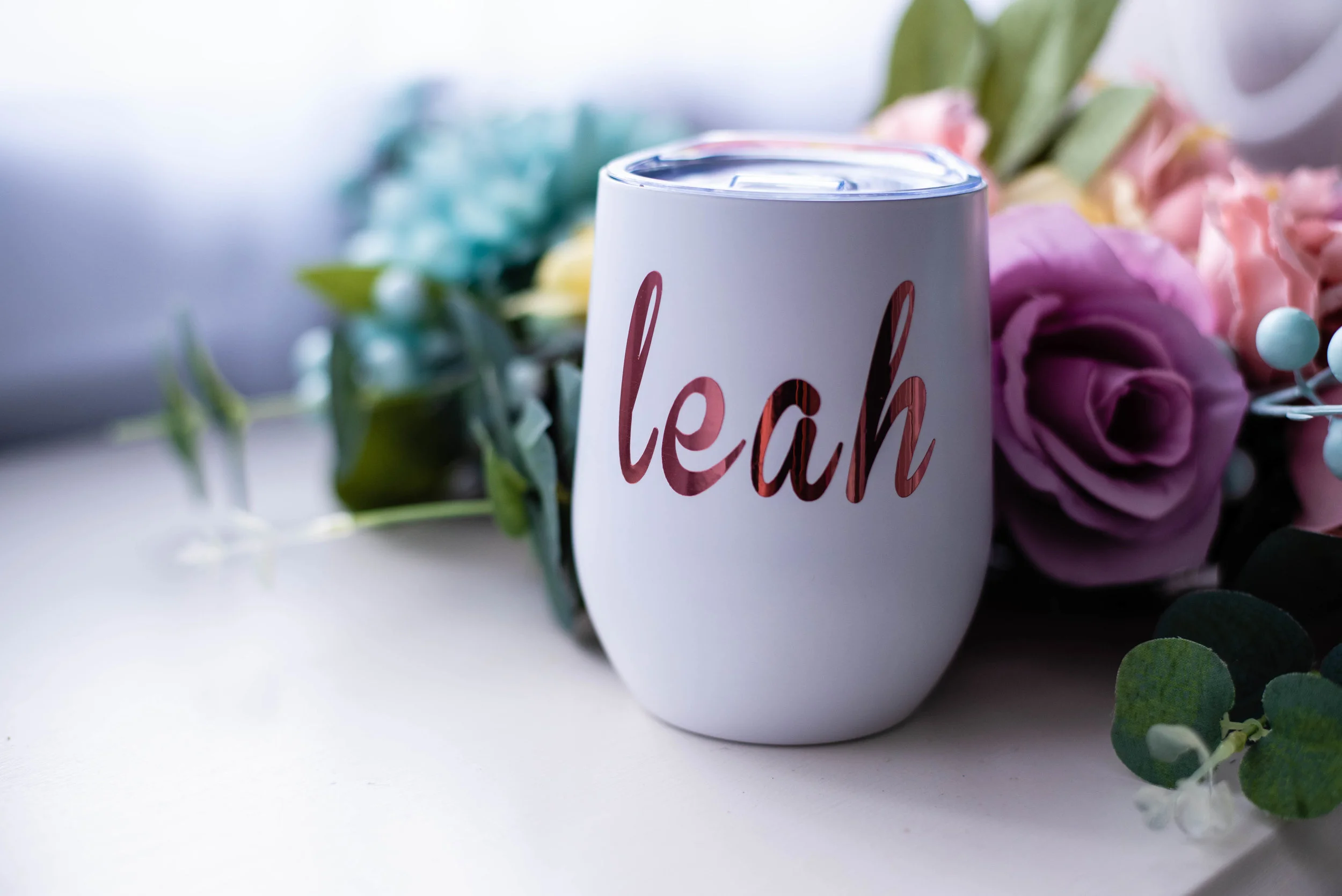 Stemless wine cup from Bridesmaid Gifts Boutique in white with personalized rose gold vinyl lettering. So cute!